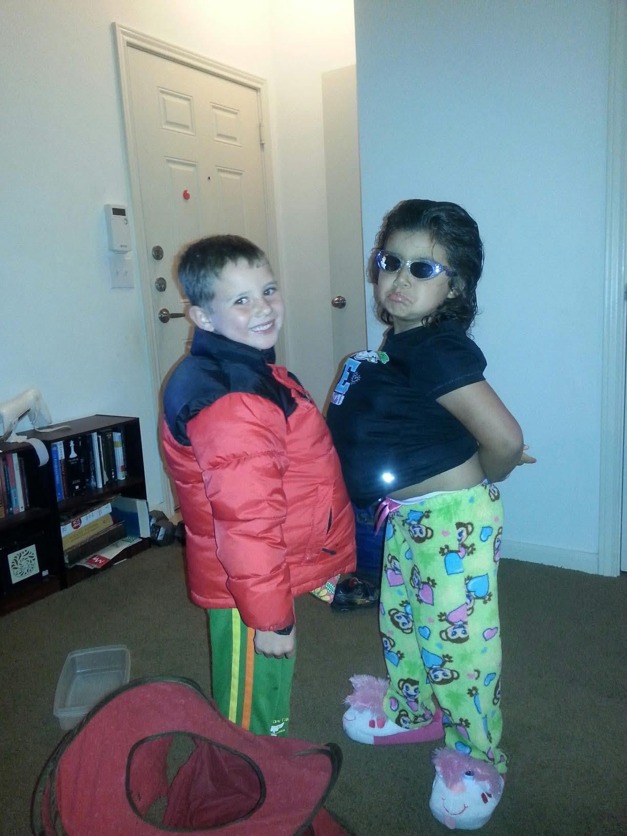 A boy and girl standing in a room