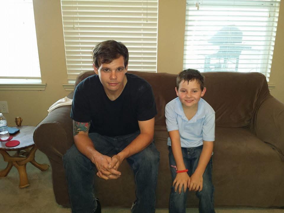 A man and boy sitting on a couch