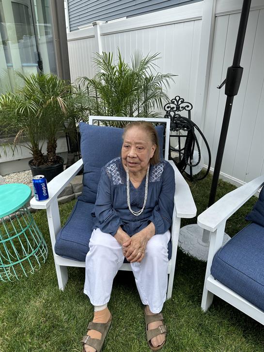 An old woman sitting in a chair