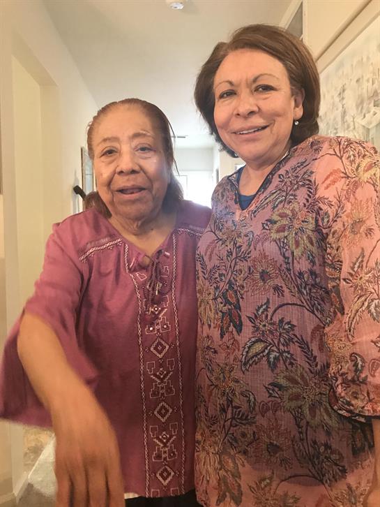 Two women standing together smiling