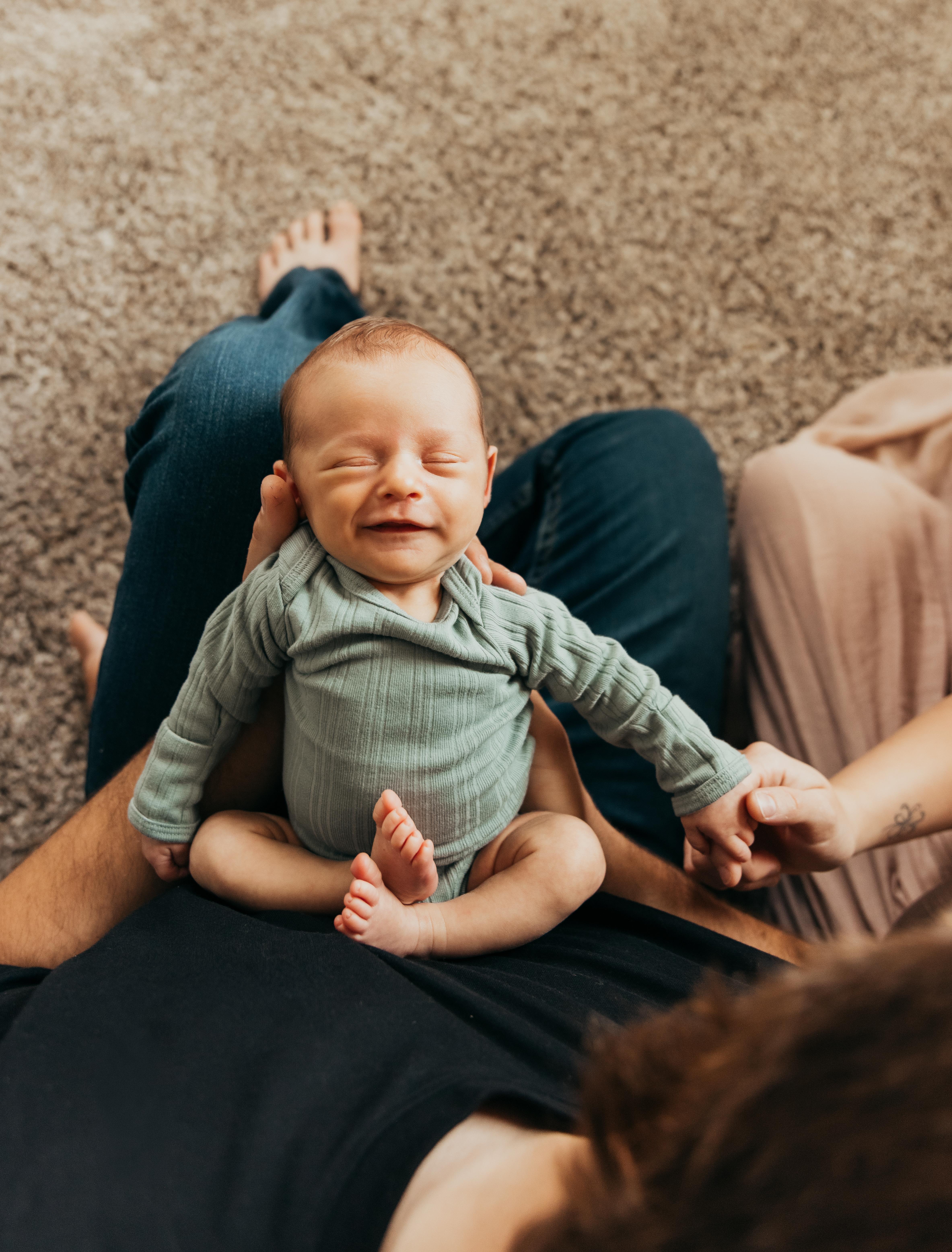 A baby lying on a person's lap
