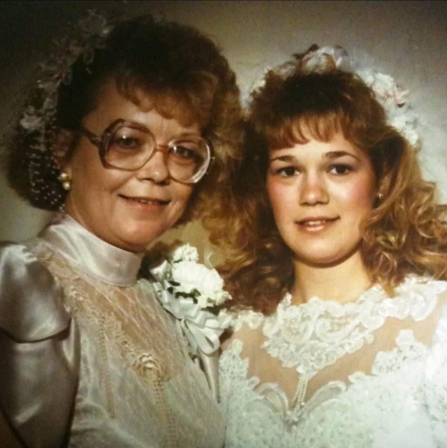 A woman and a woman in wedding dresses