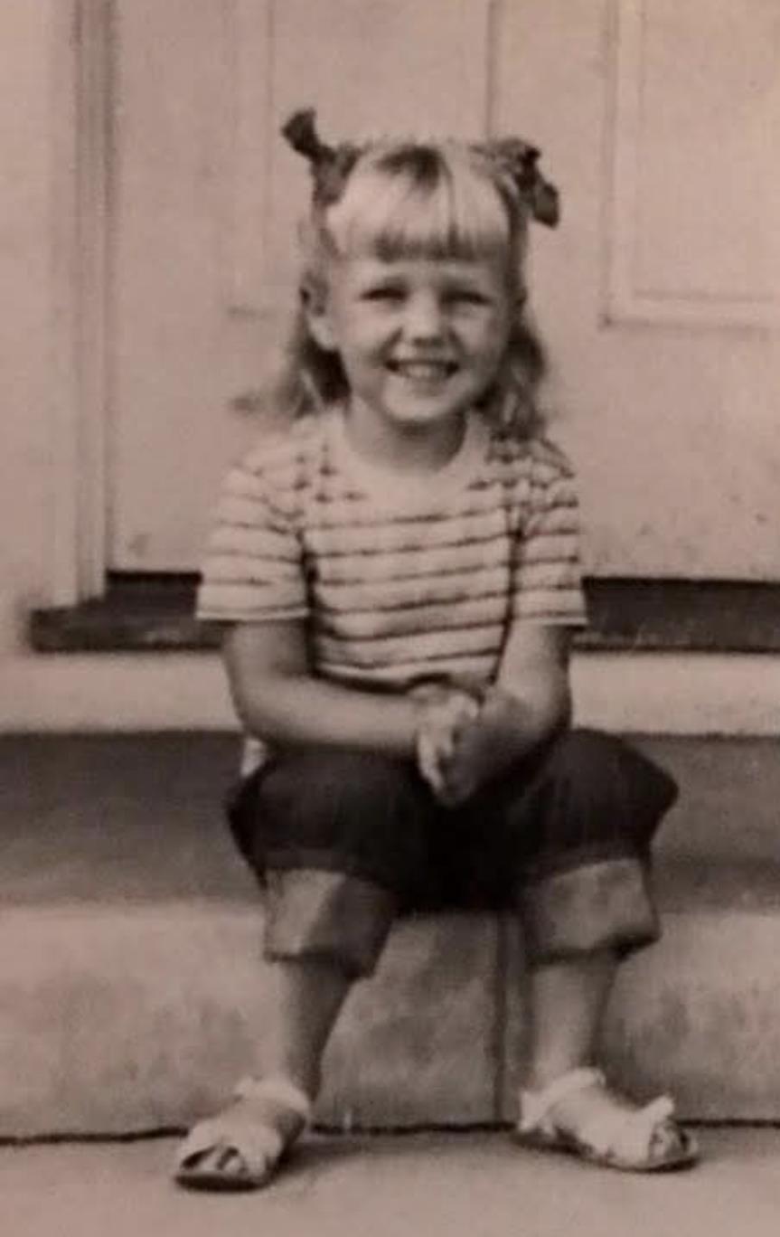 A child sitting on a porch