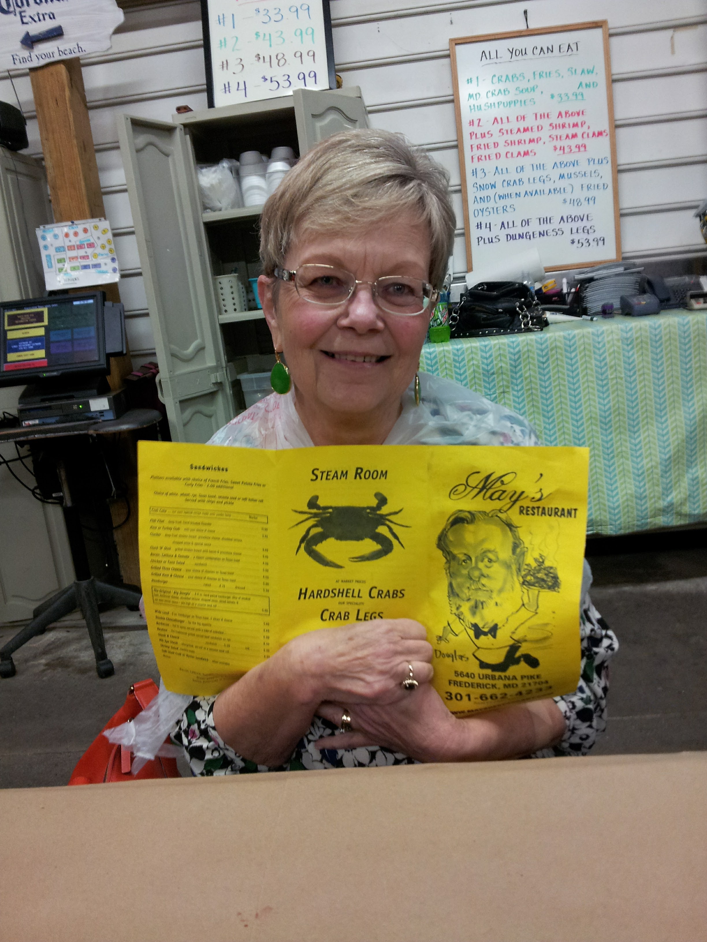 A woman holding a yellow menu