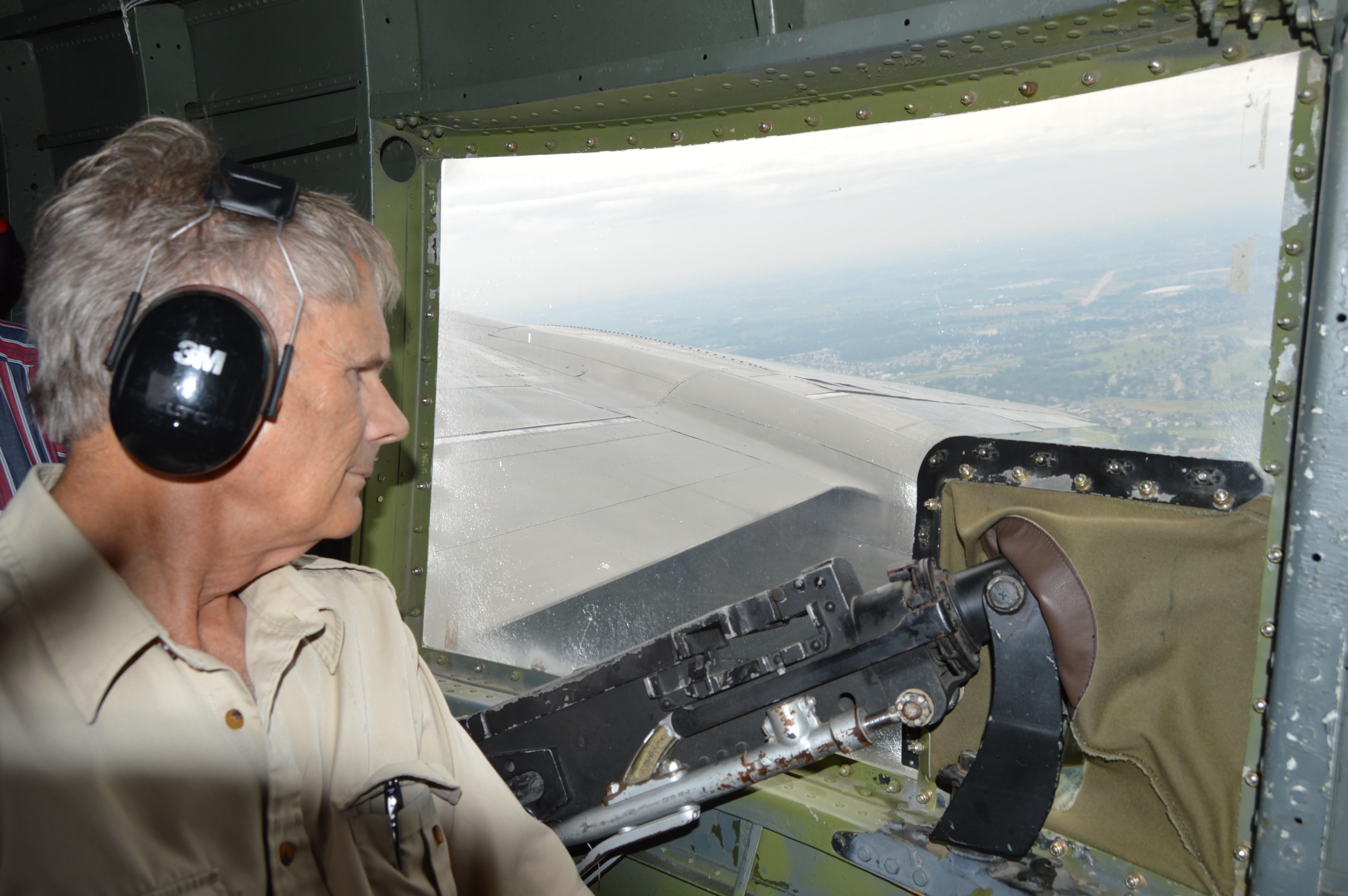 A man in a pilot's seat looking out of a window