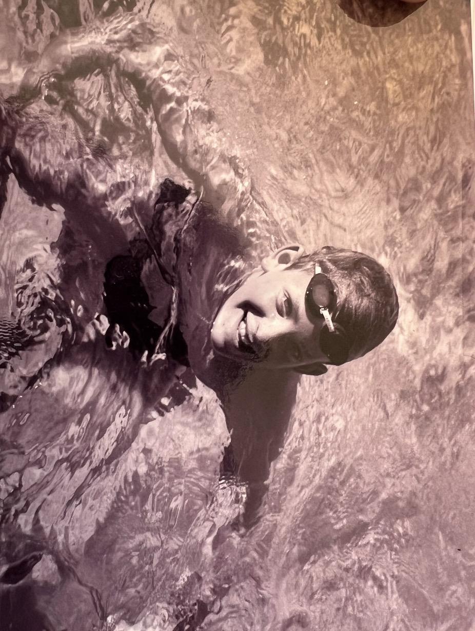 A man in a pool with goggles