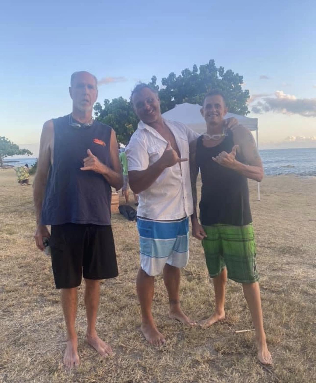 A group of men standing on a beach