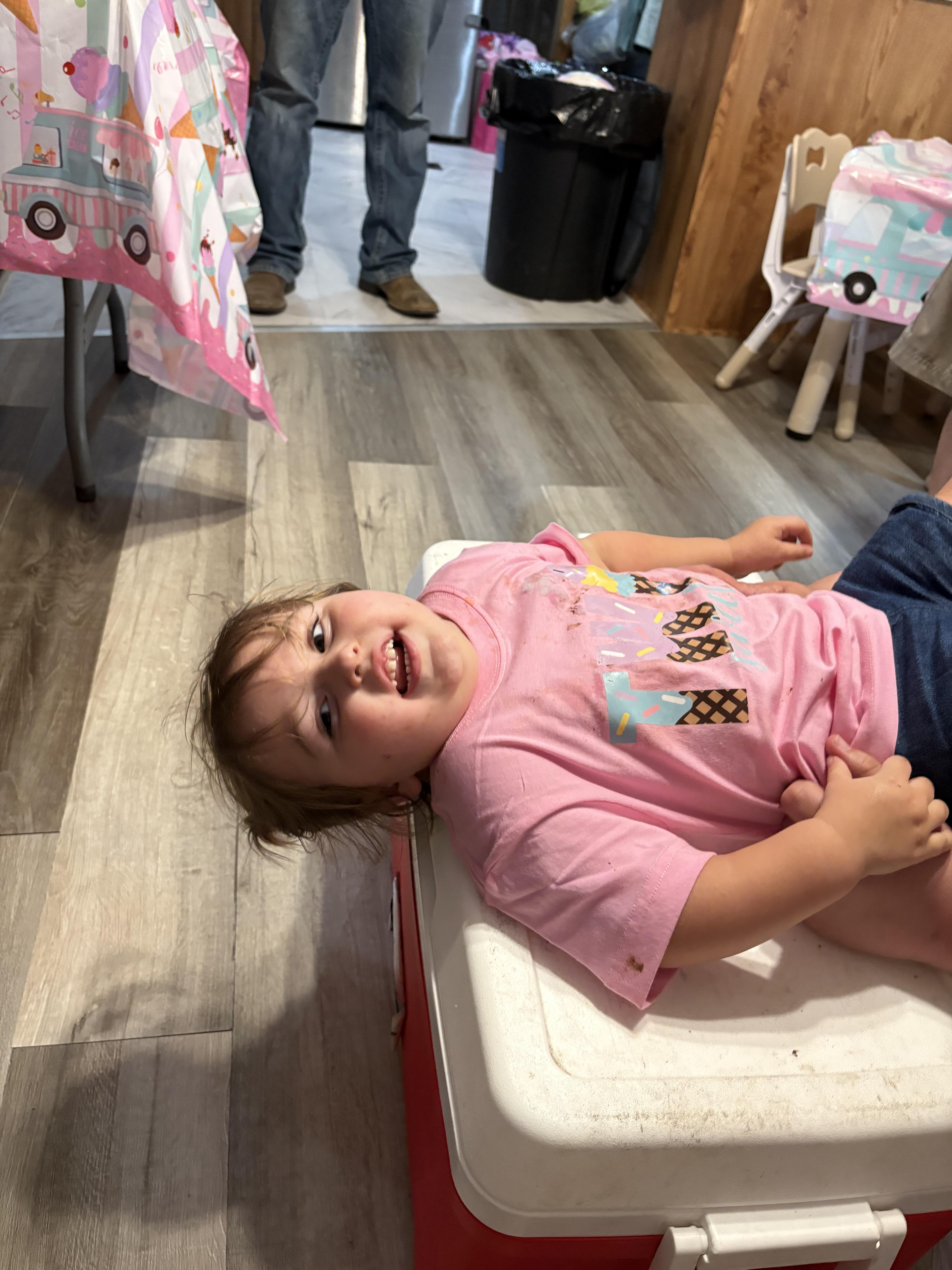 A child lying on a cooler