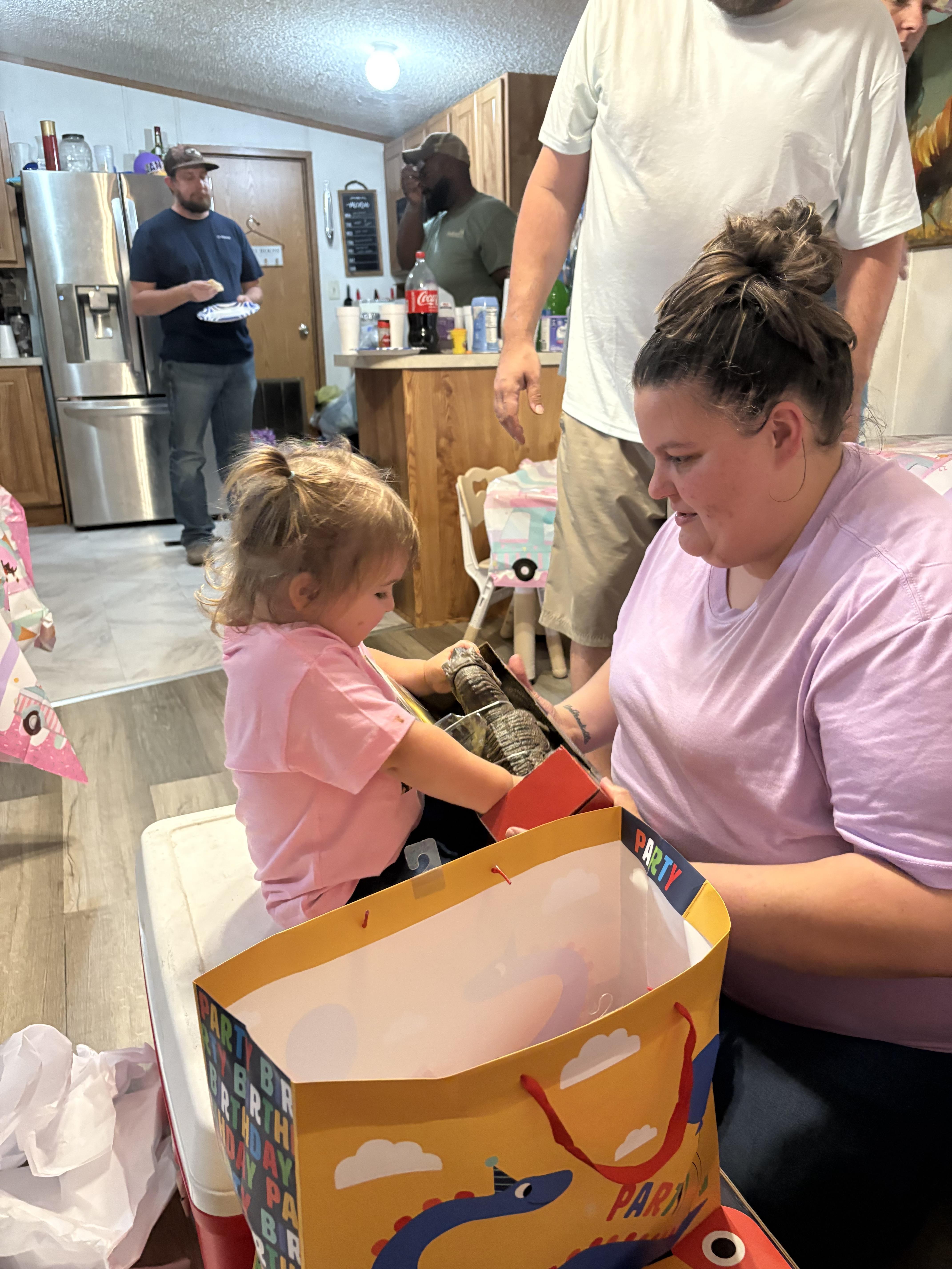 A woman and a child in a room with a bag