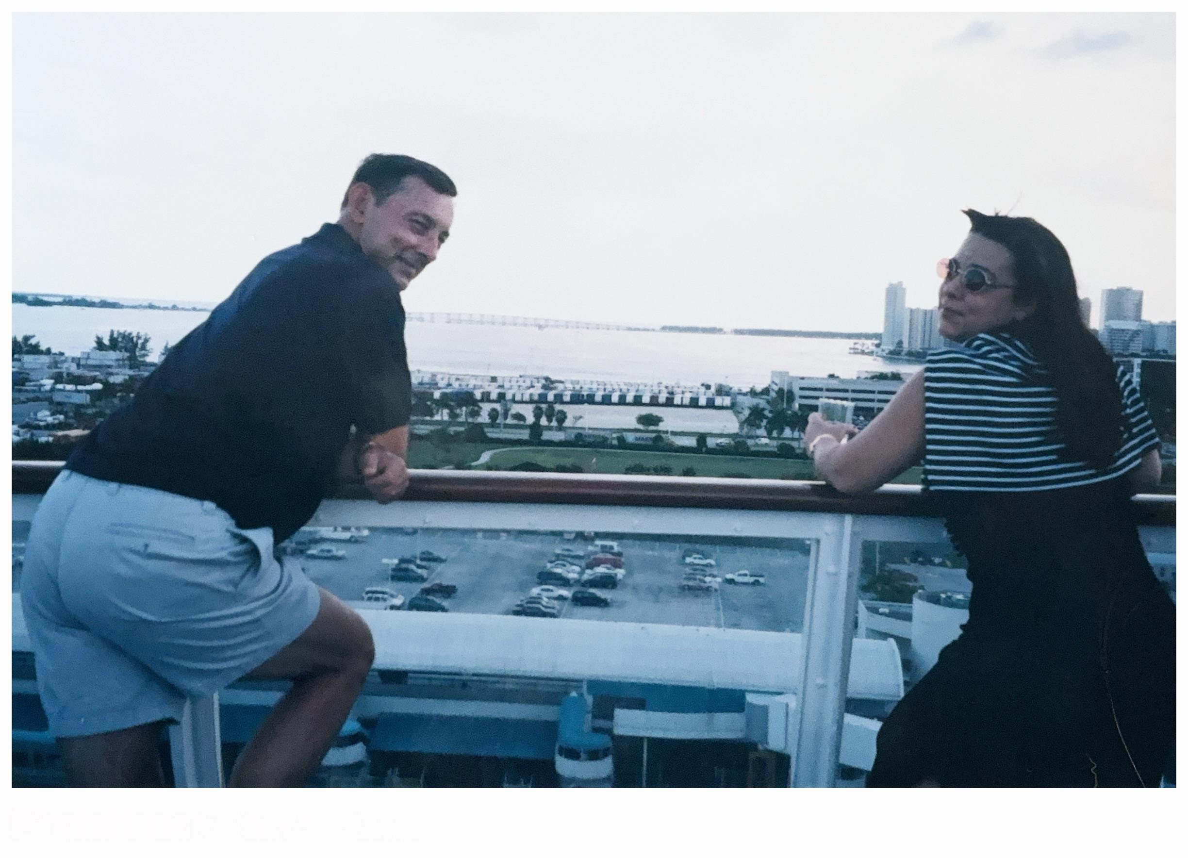 A man and woman sitting on a balcony