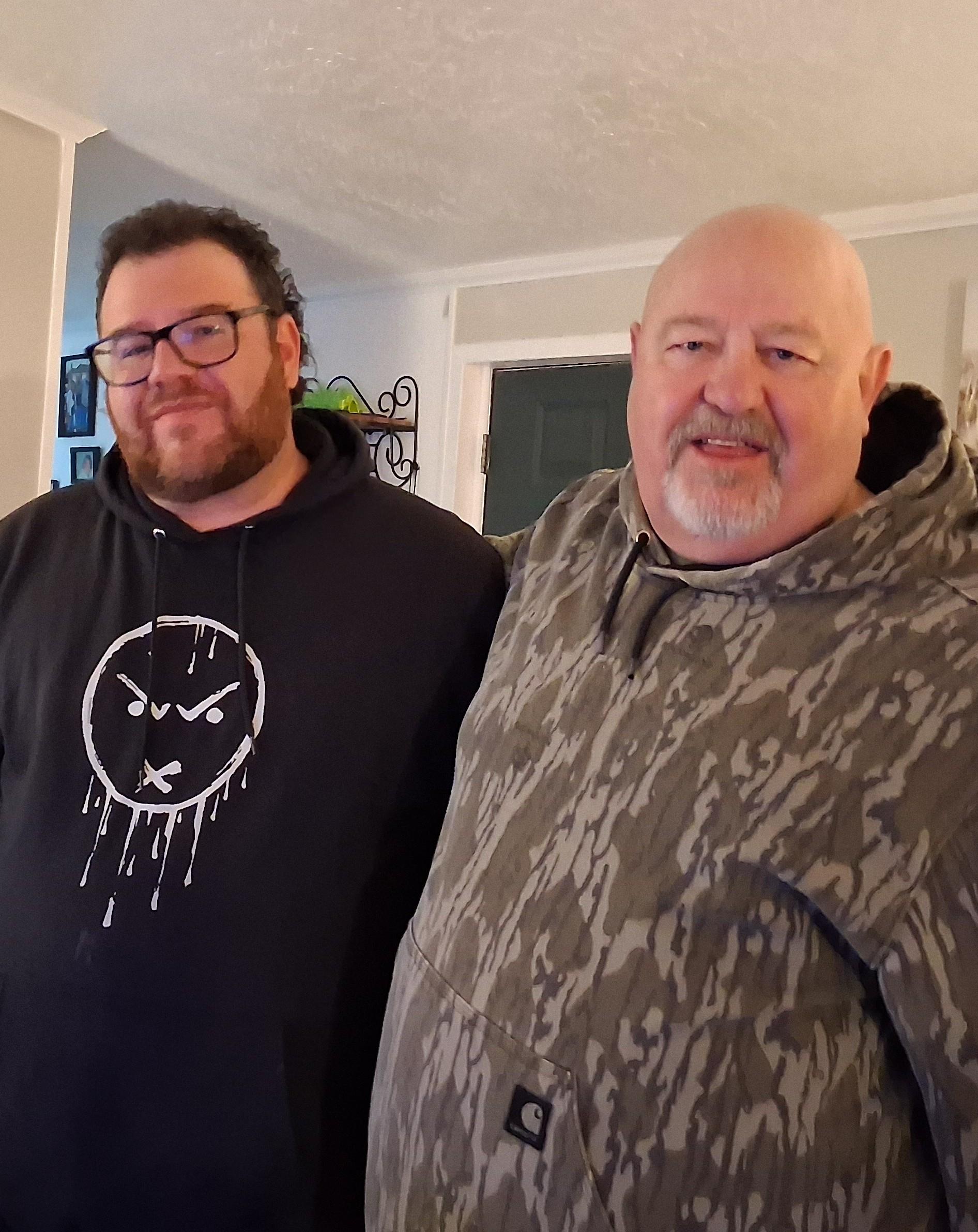 Two men standing together in a room