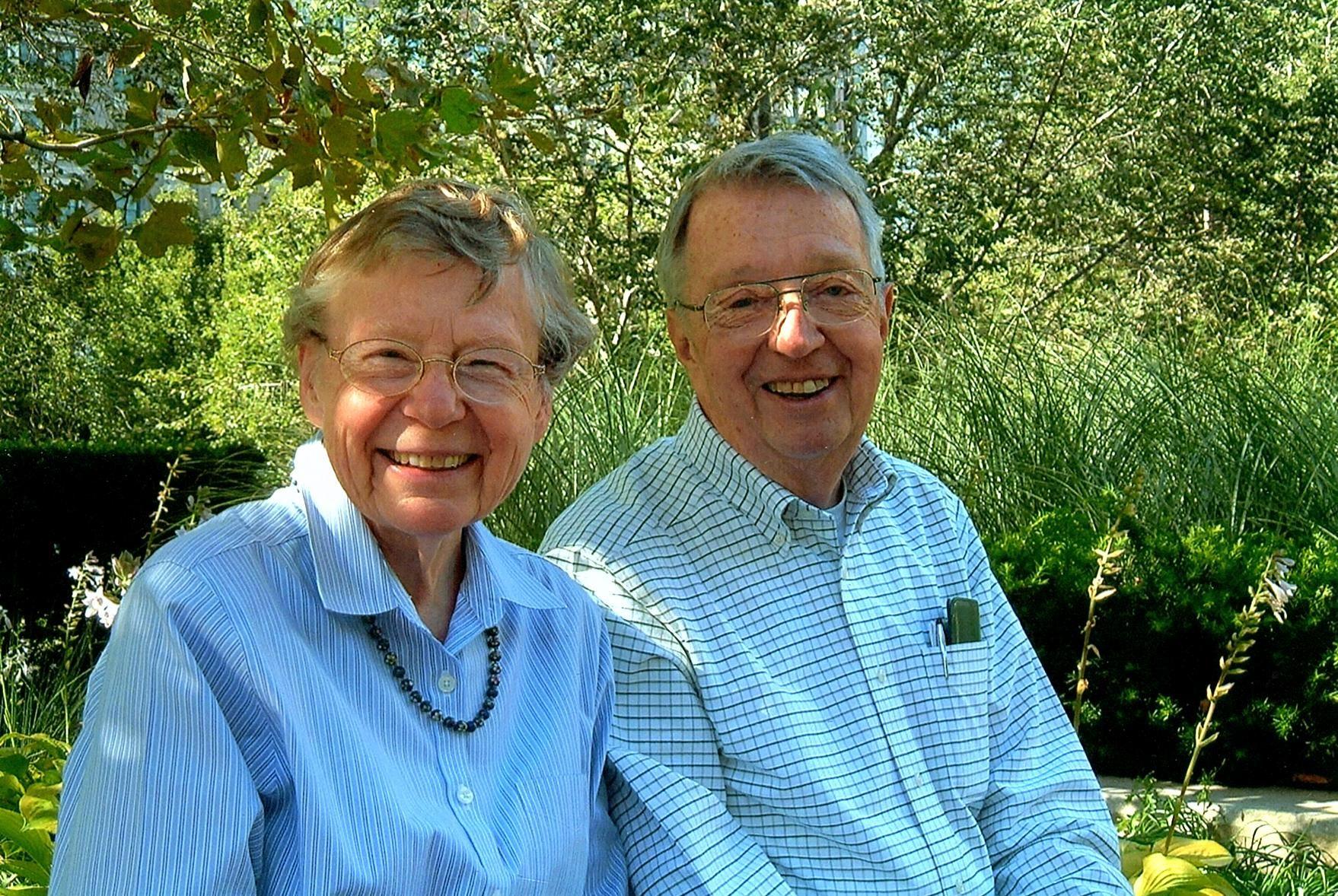 A man and woman sitting in a park