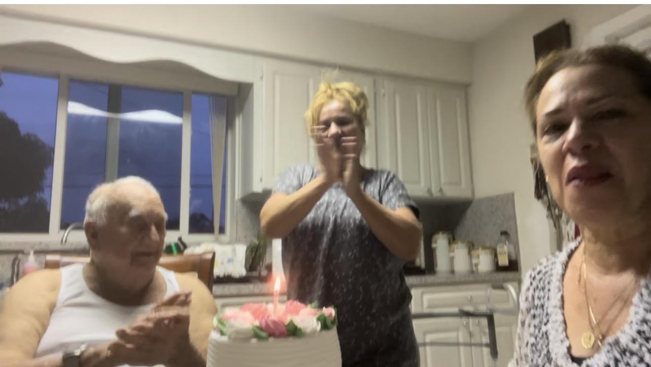 A woman standing in front of a cake