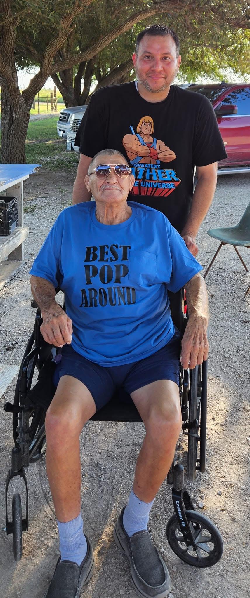 A man pushing an older woman in a wheelchair