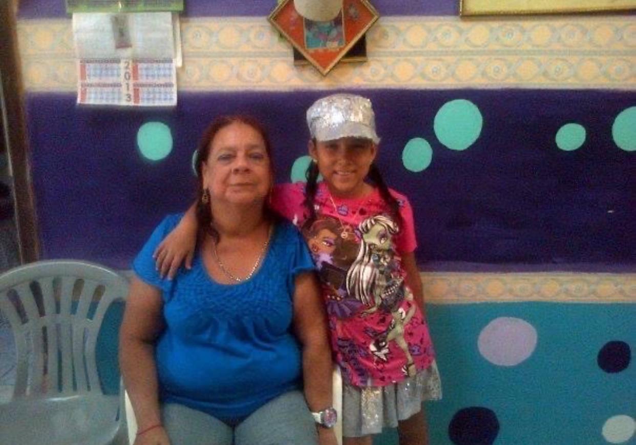 A woman and a girl posing for a picture