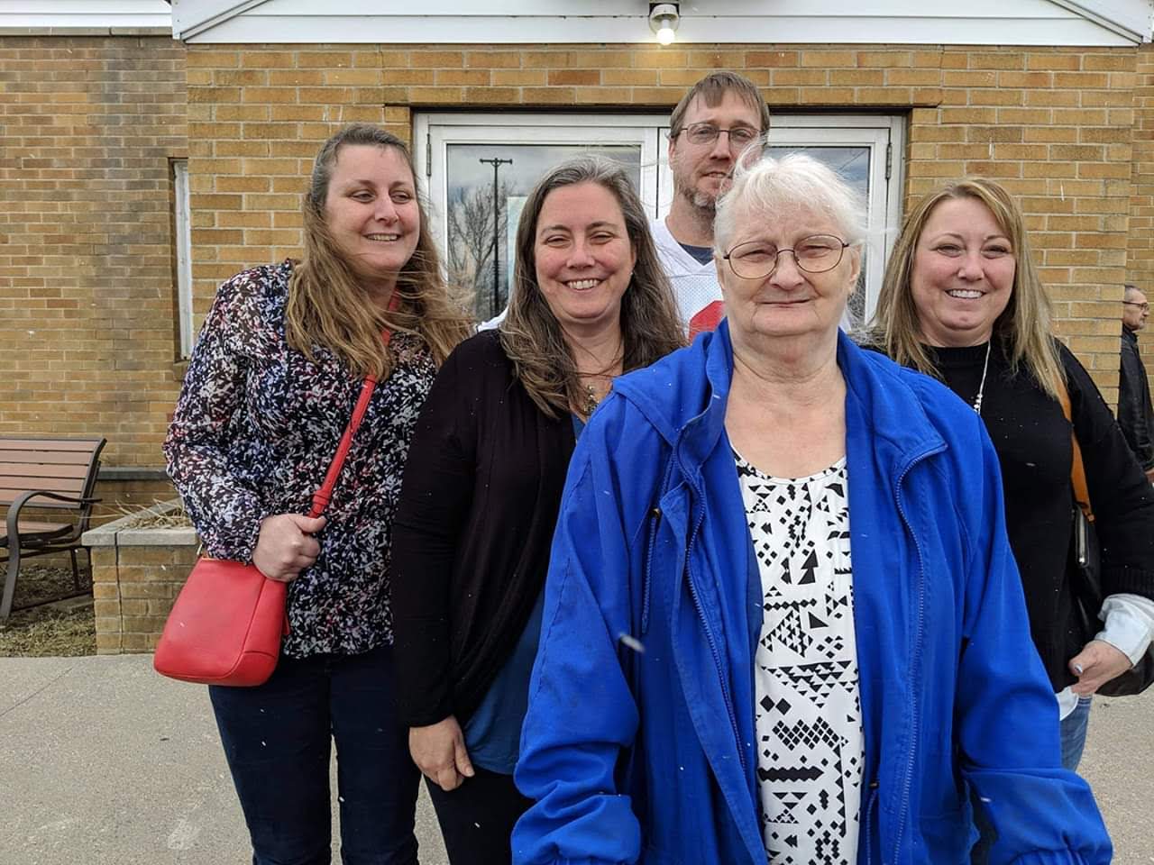 A group of people standing together outside a building