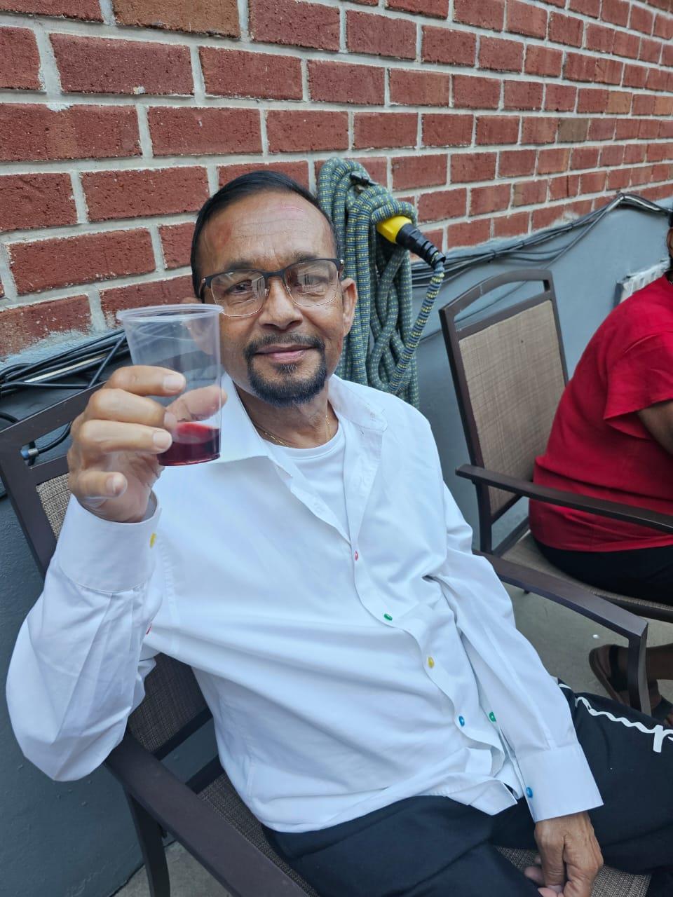 A man holding a cup of liquid