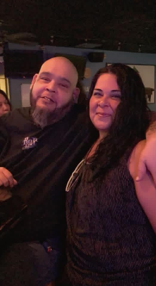 A man and woman posing for a picture