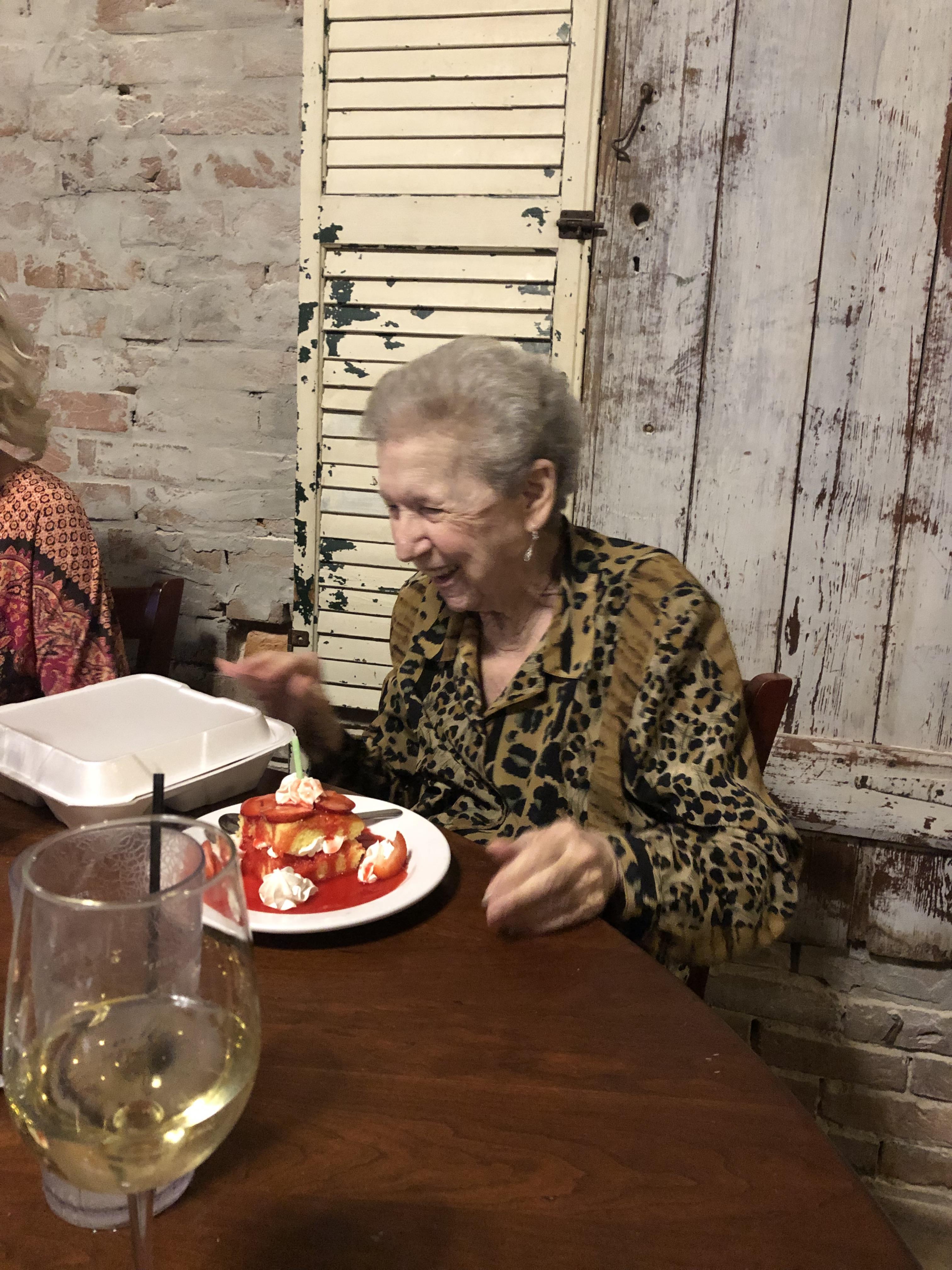A woman sitting at a table with food on it