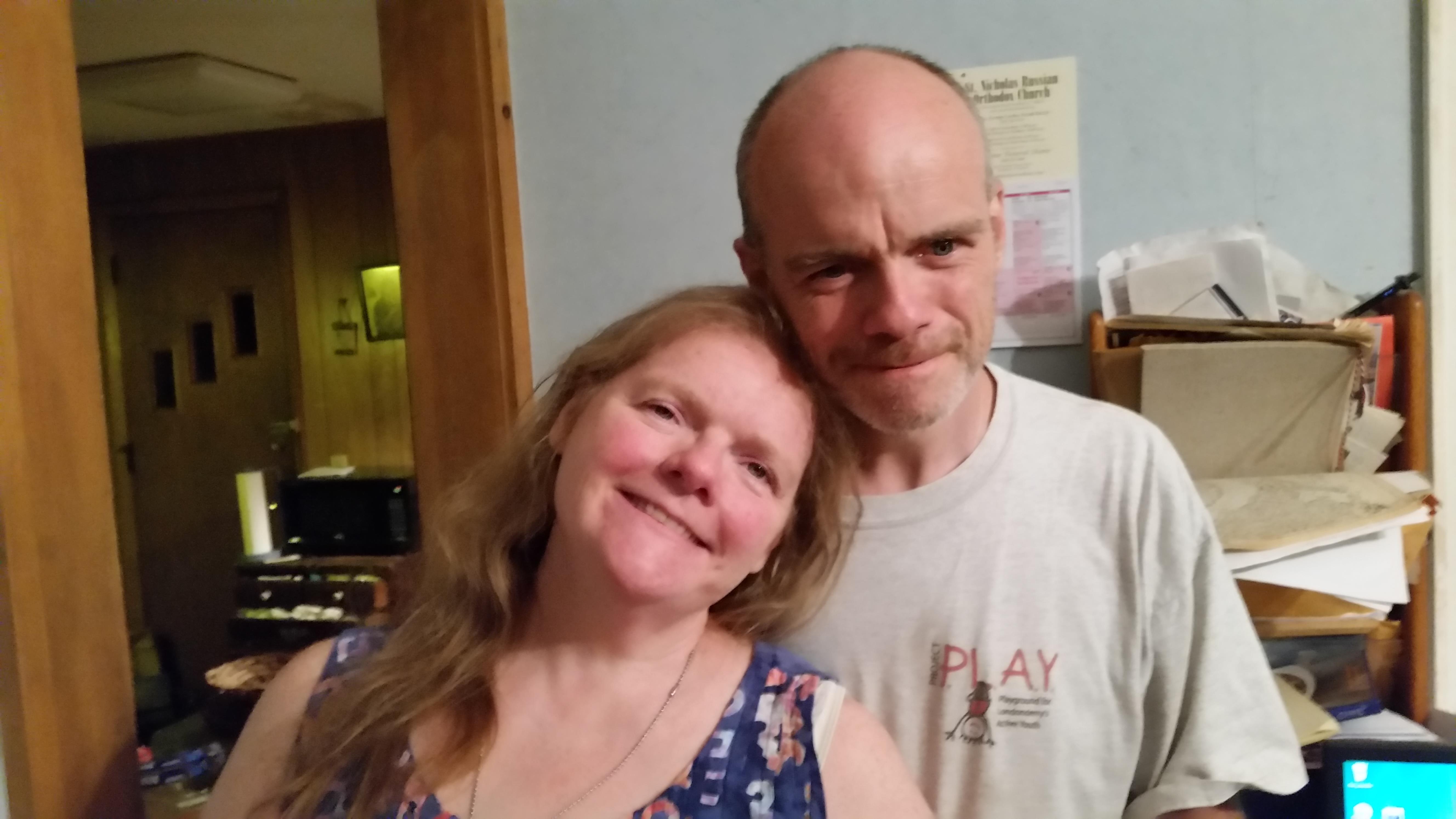A man and woman posing for a picture