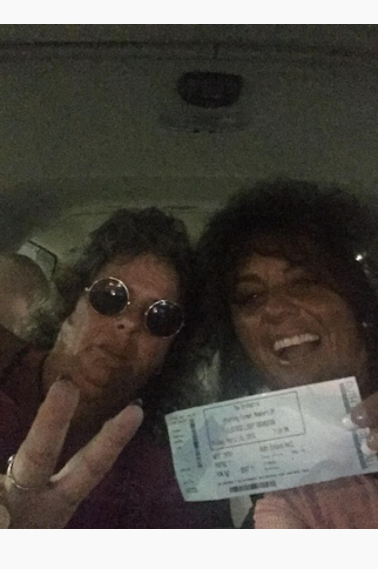 A couple of people holding up a ticket