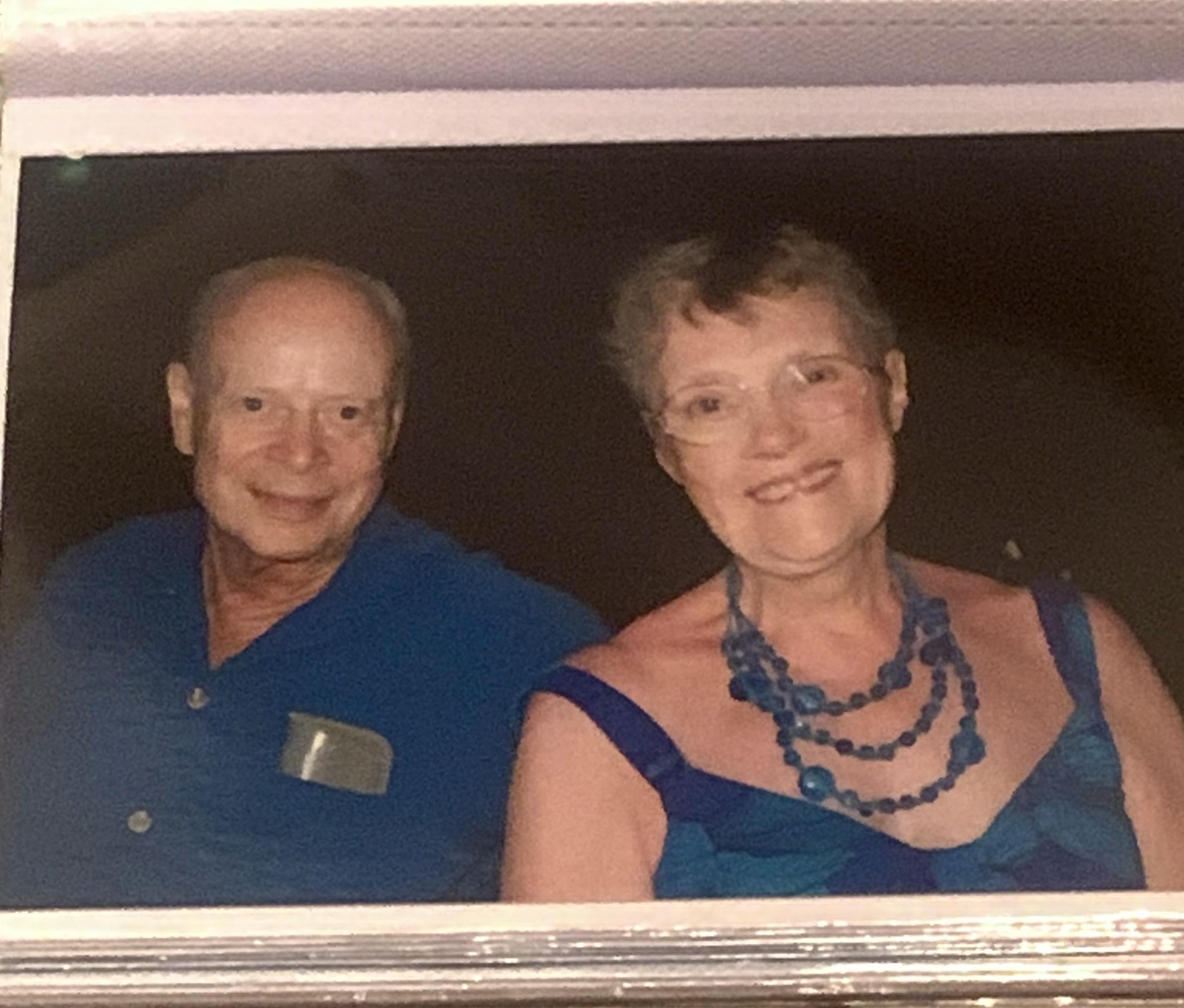 A man and woman smiling at the camera