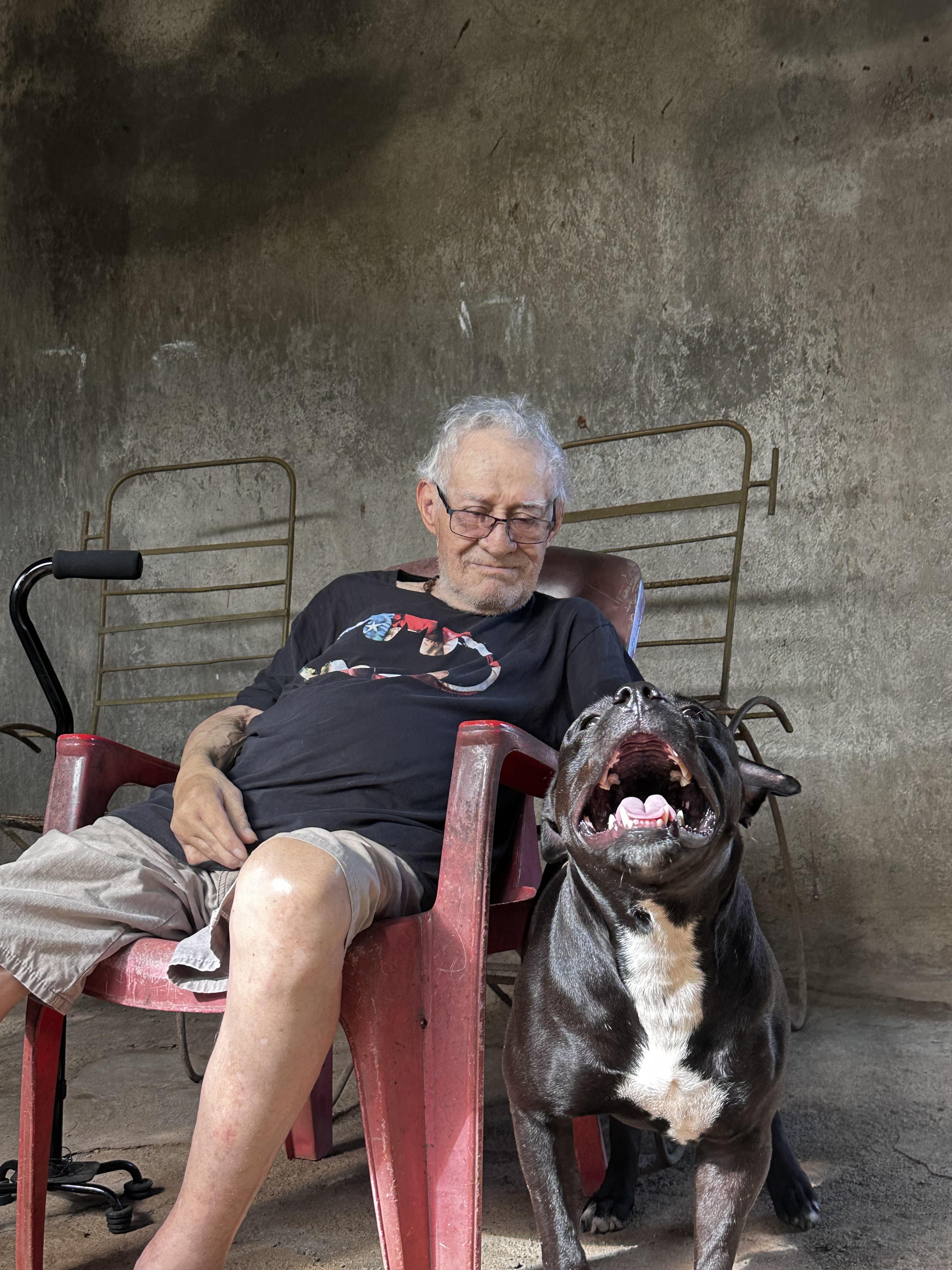 A man sitting in a chair with a dog
