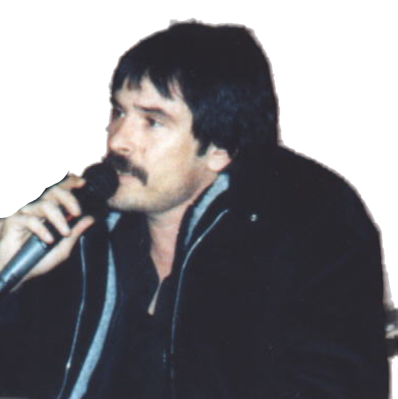 A man with a mustache holding a microphone