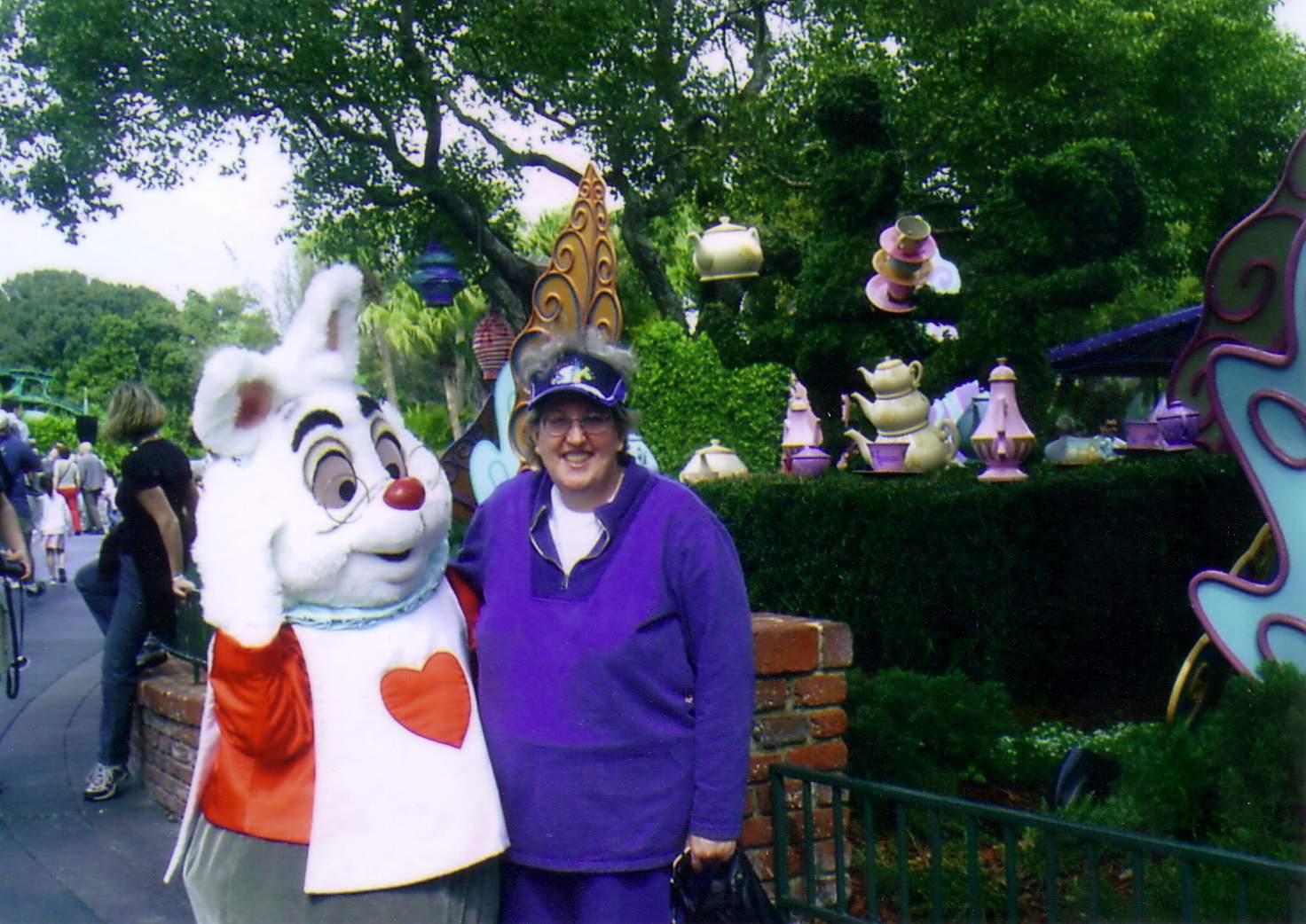 A woman standing next to a person in a rabbit garment