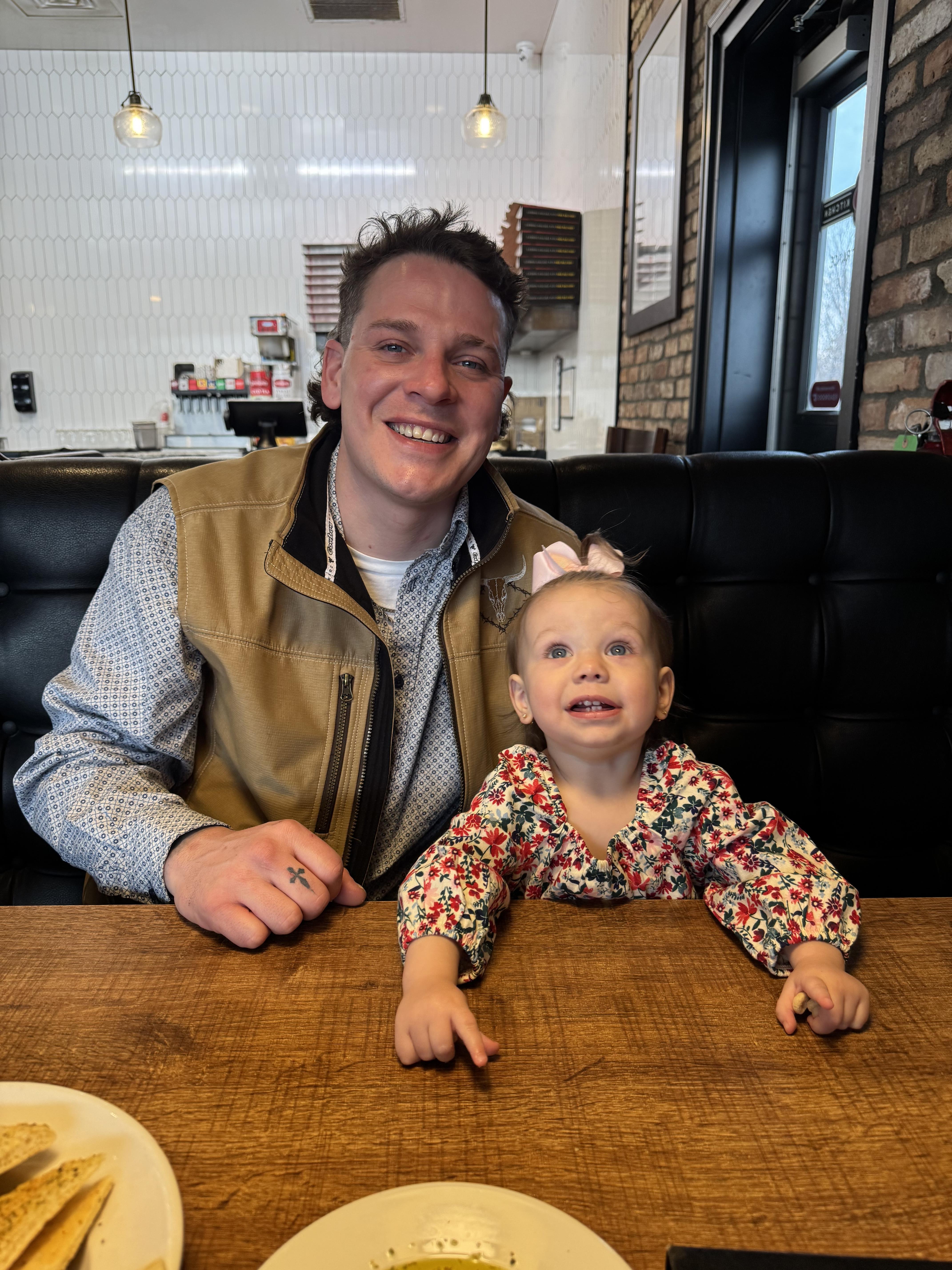 A man and a baby sitting at a table