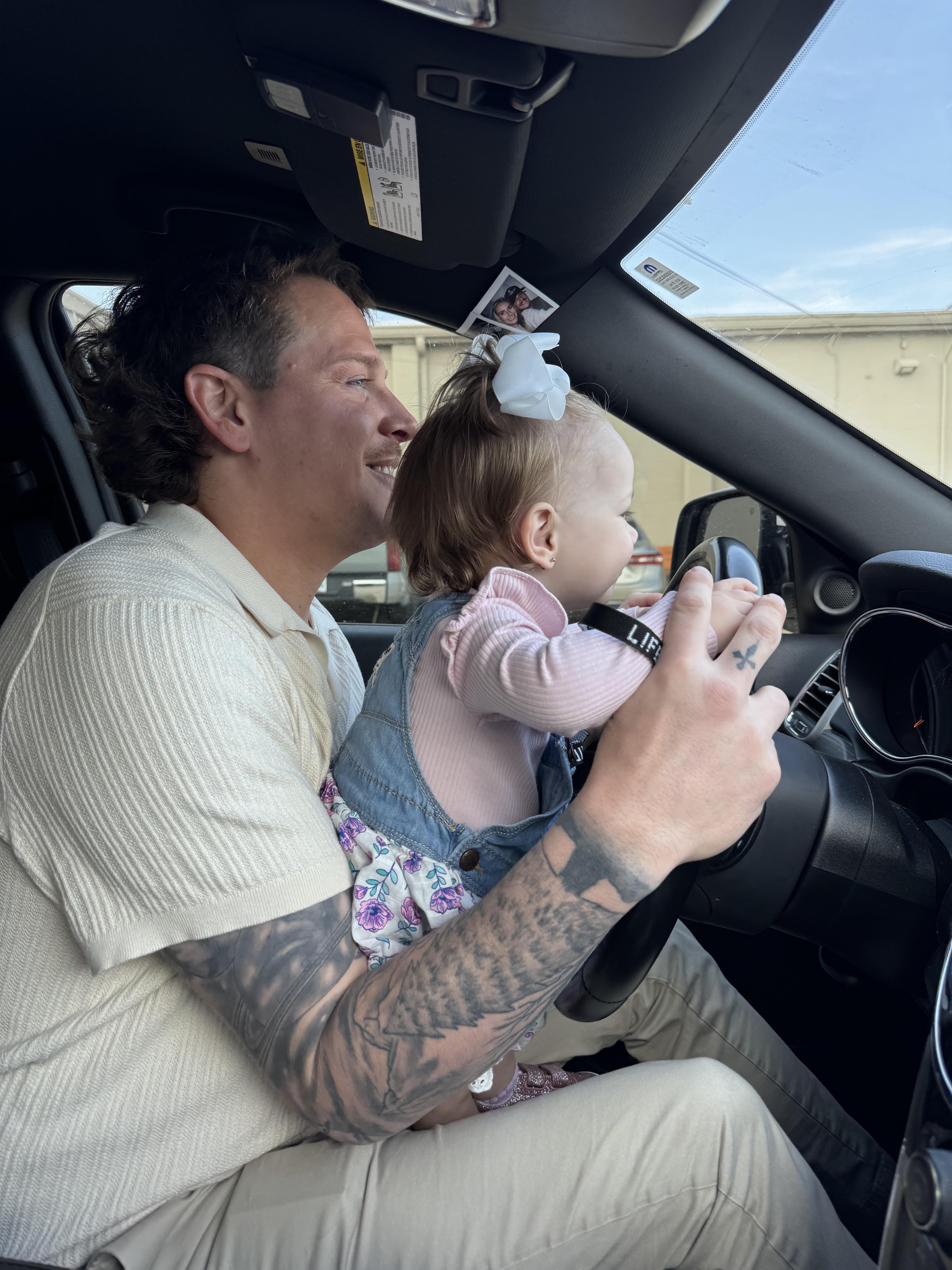 A man holding a baby in a car
