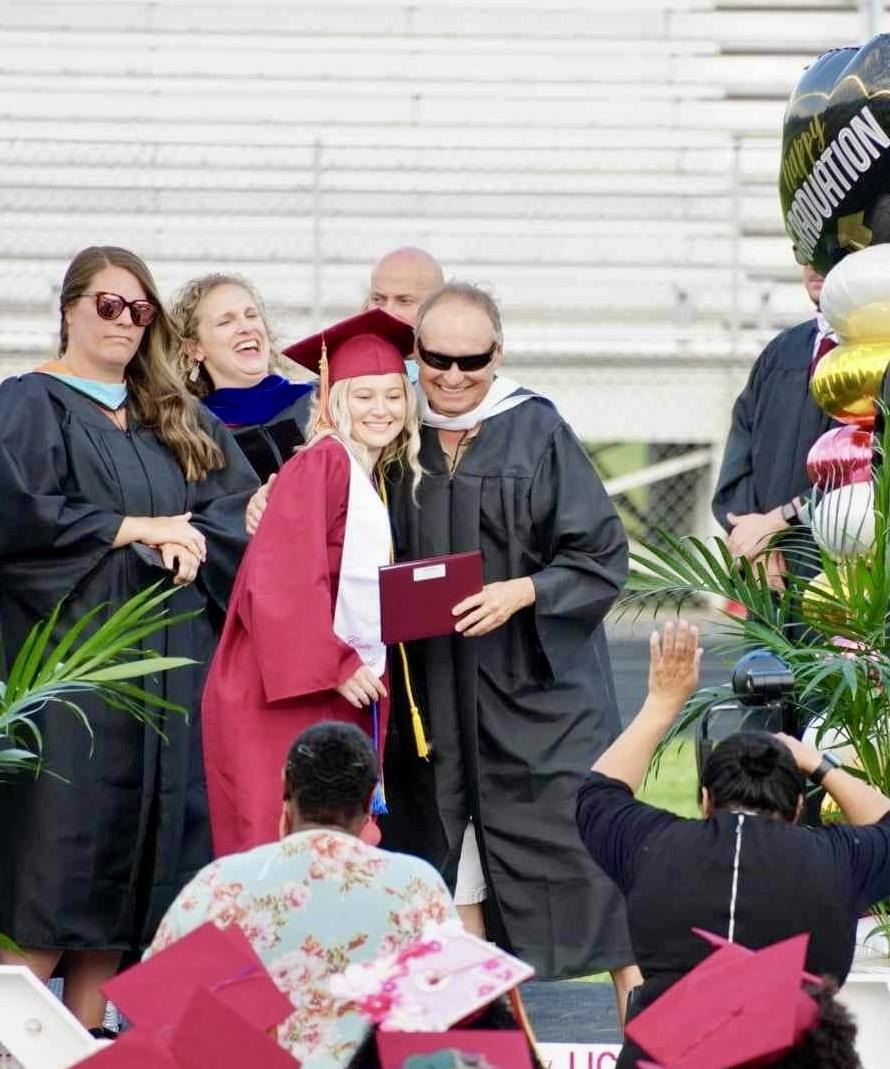 A group of people in graduation gowns