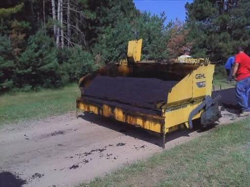 A yellow machine on a dirt road