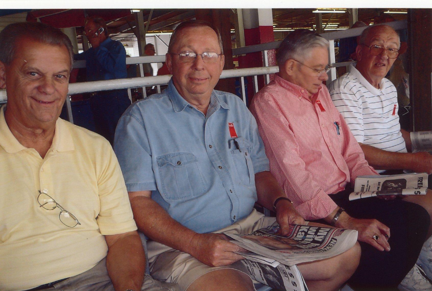 A group of men sitting on a bench