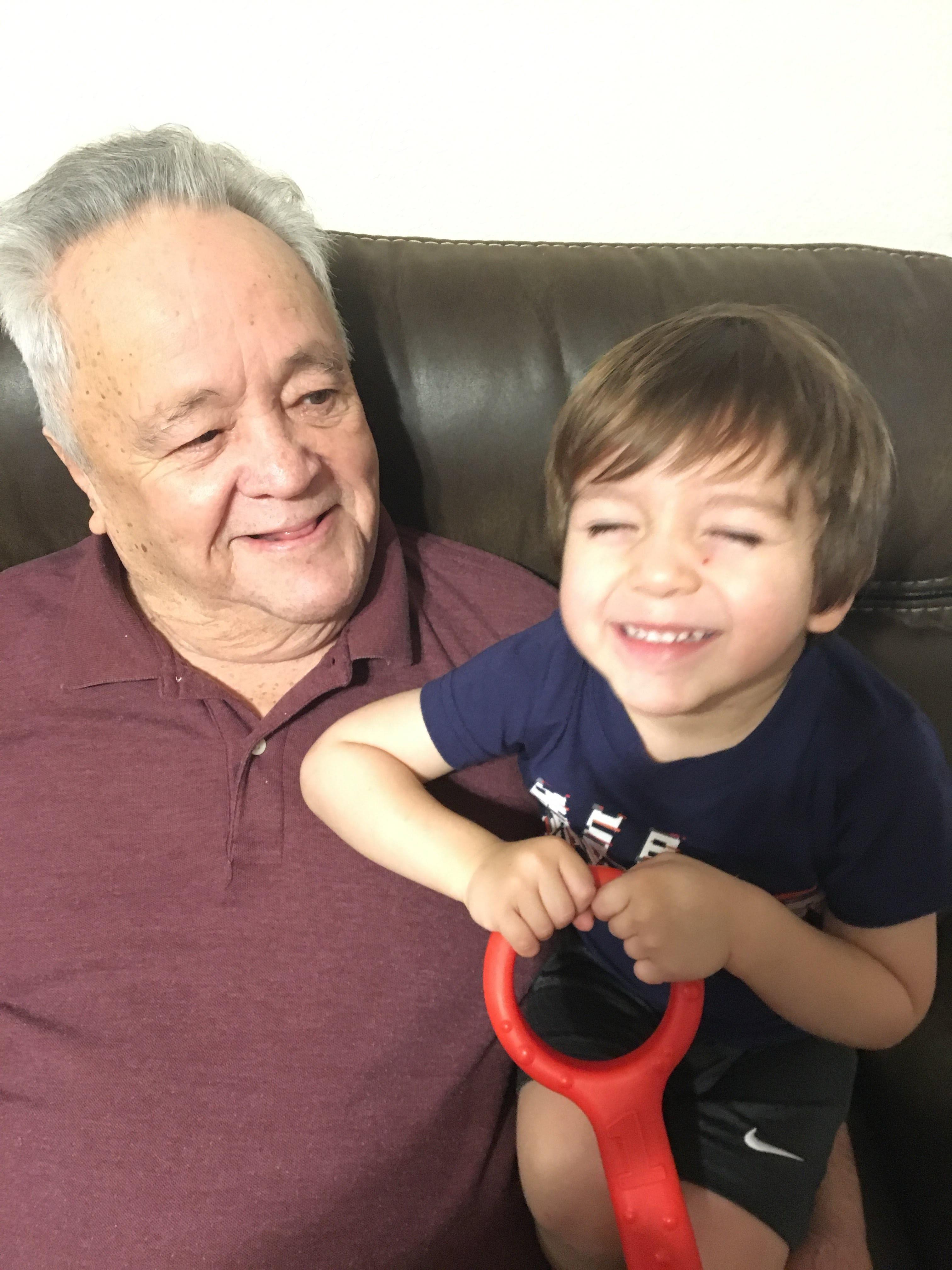 A man and child sitting on a couch