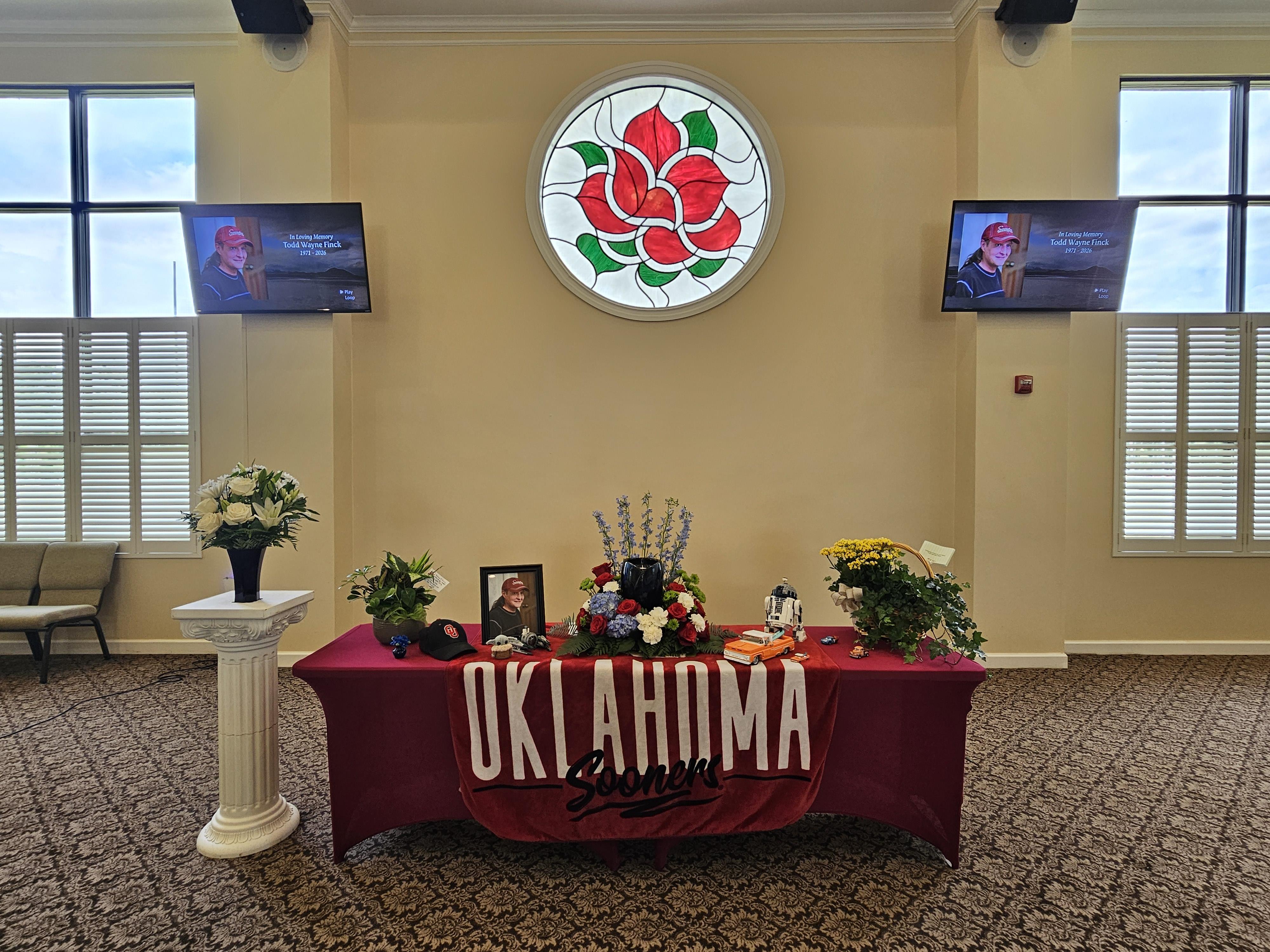 A table with flowers and a red cloth on it