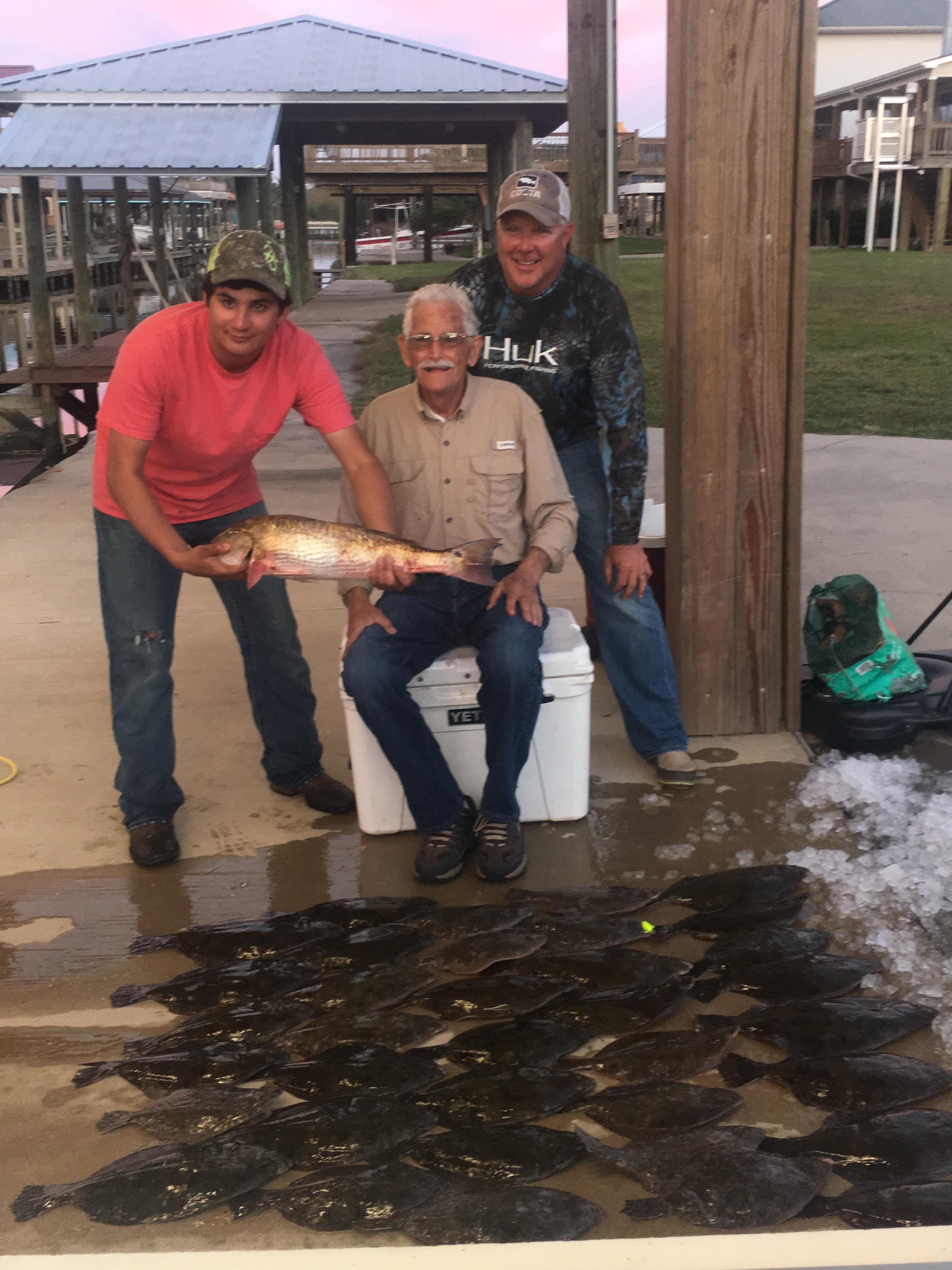 A group of men holding a fish