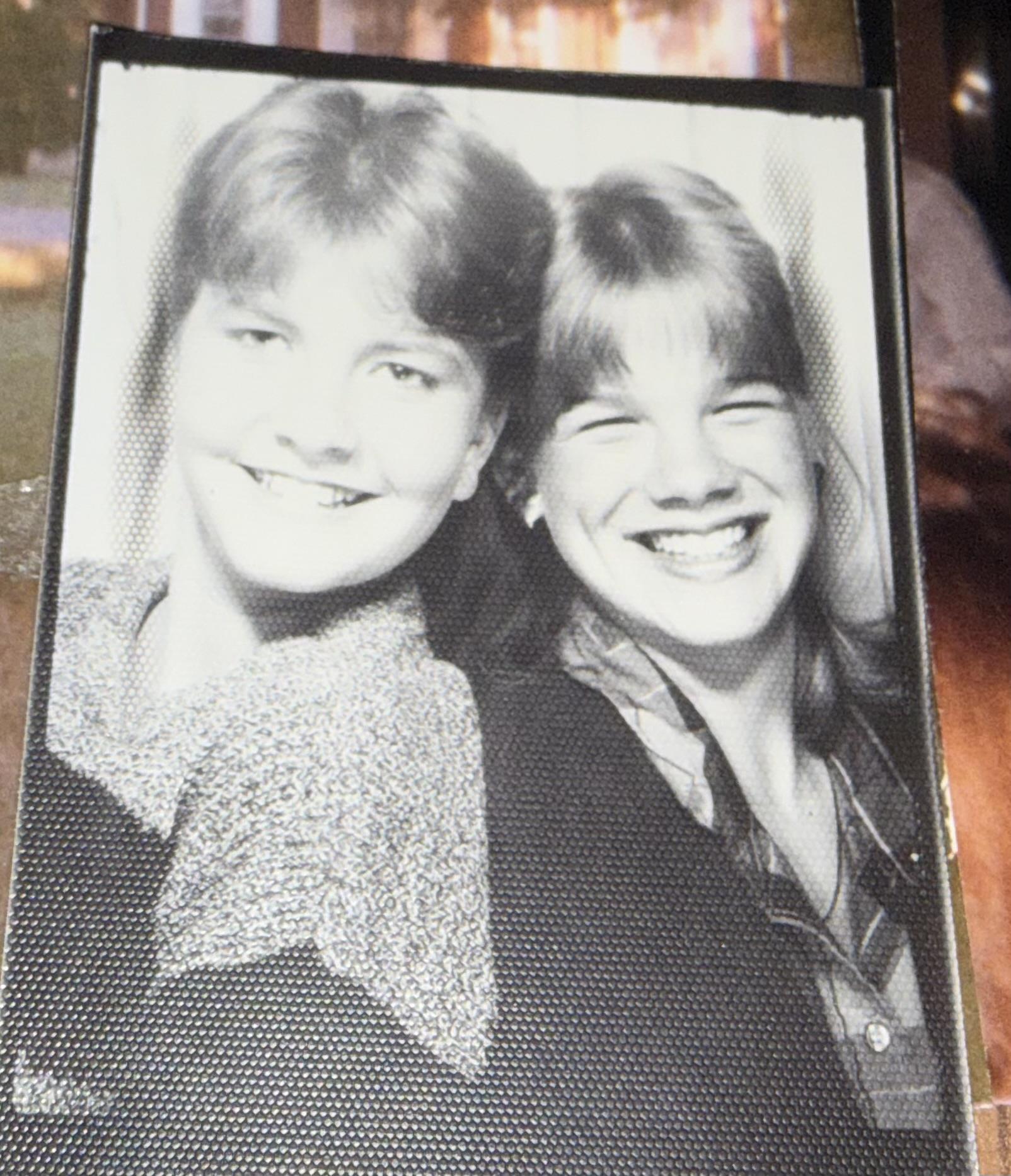 A black and white photo of two girls