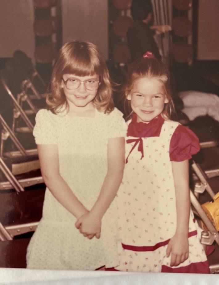 Two girls standing together smiling