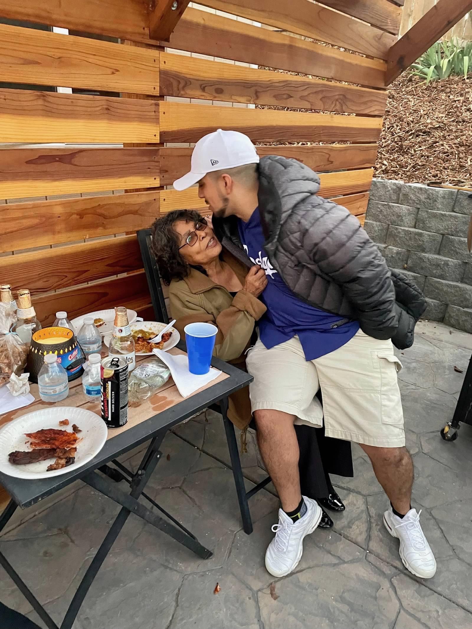 A man kissing a woman at a table