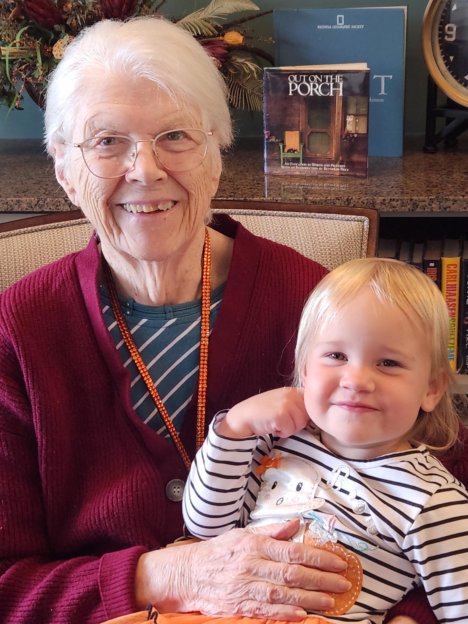 An older woman holding a young girl