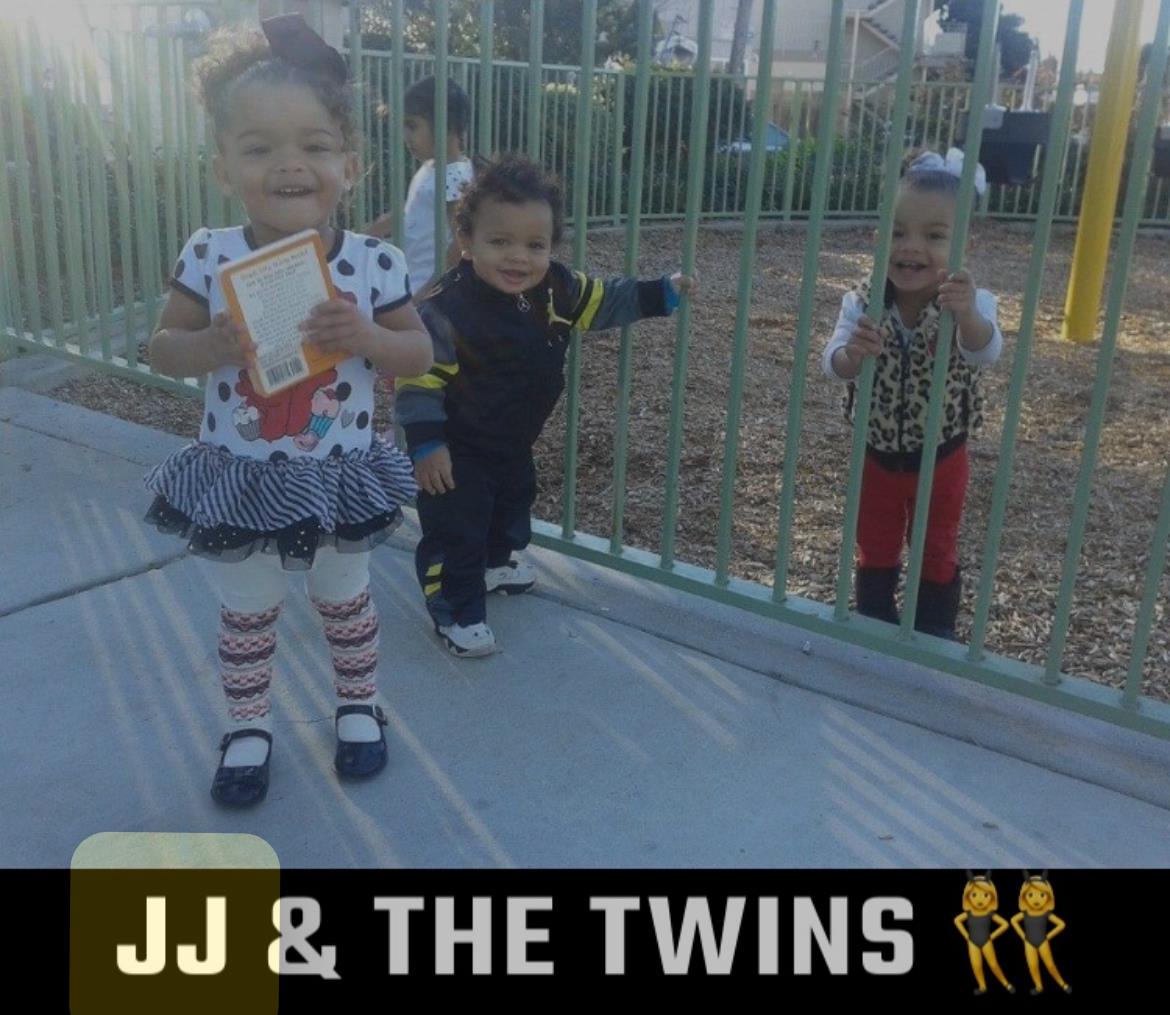 A group of children standing next to a fence