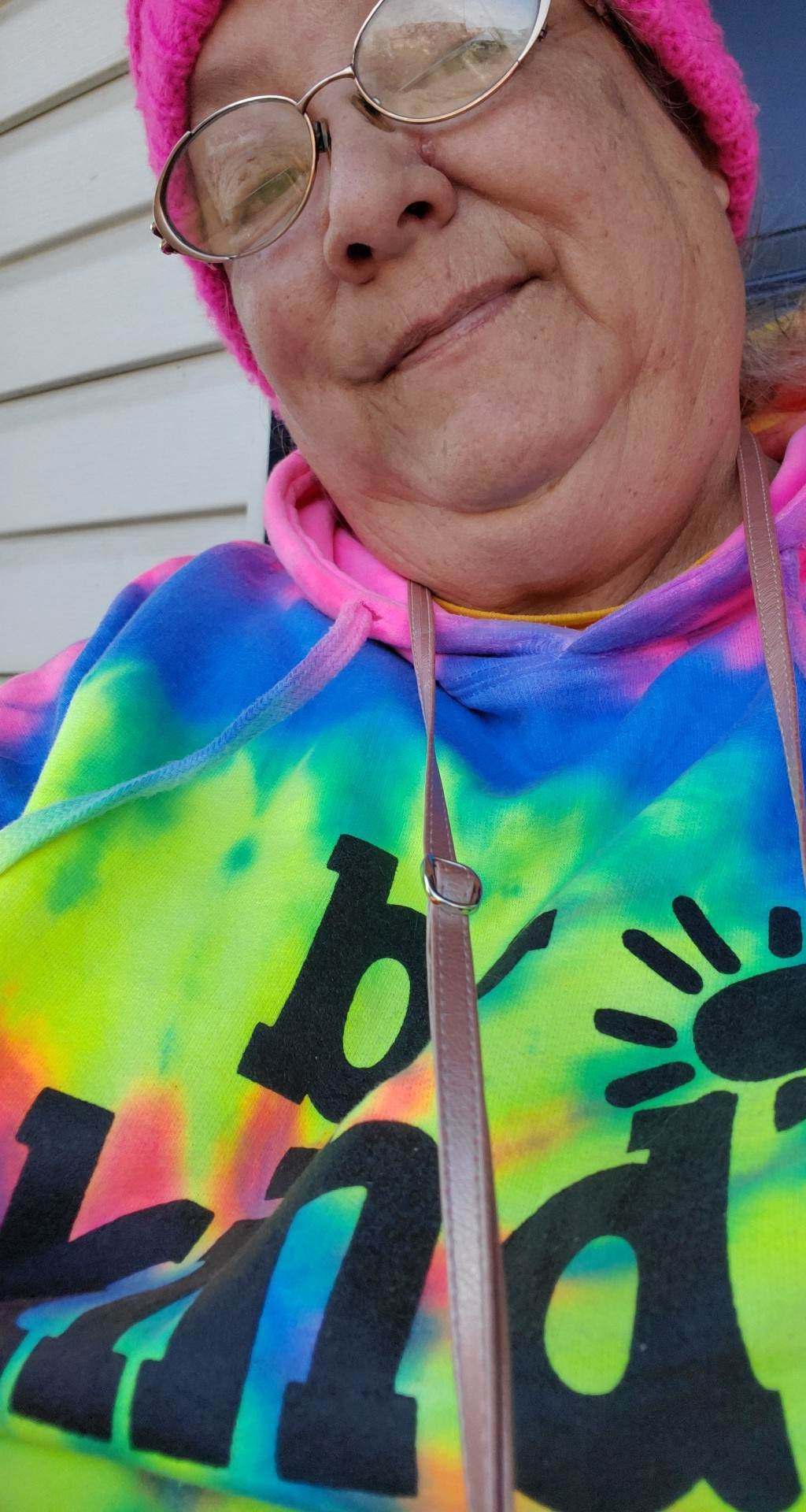A person wearing a tie dye hoodie