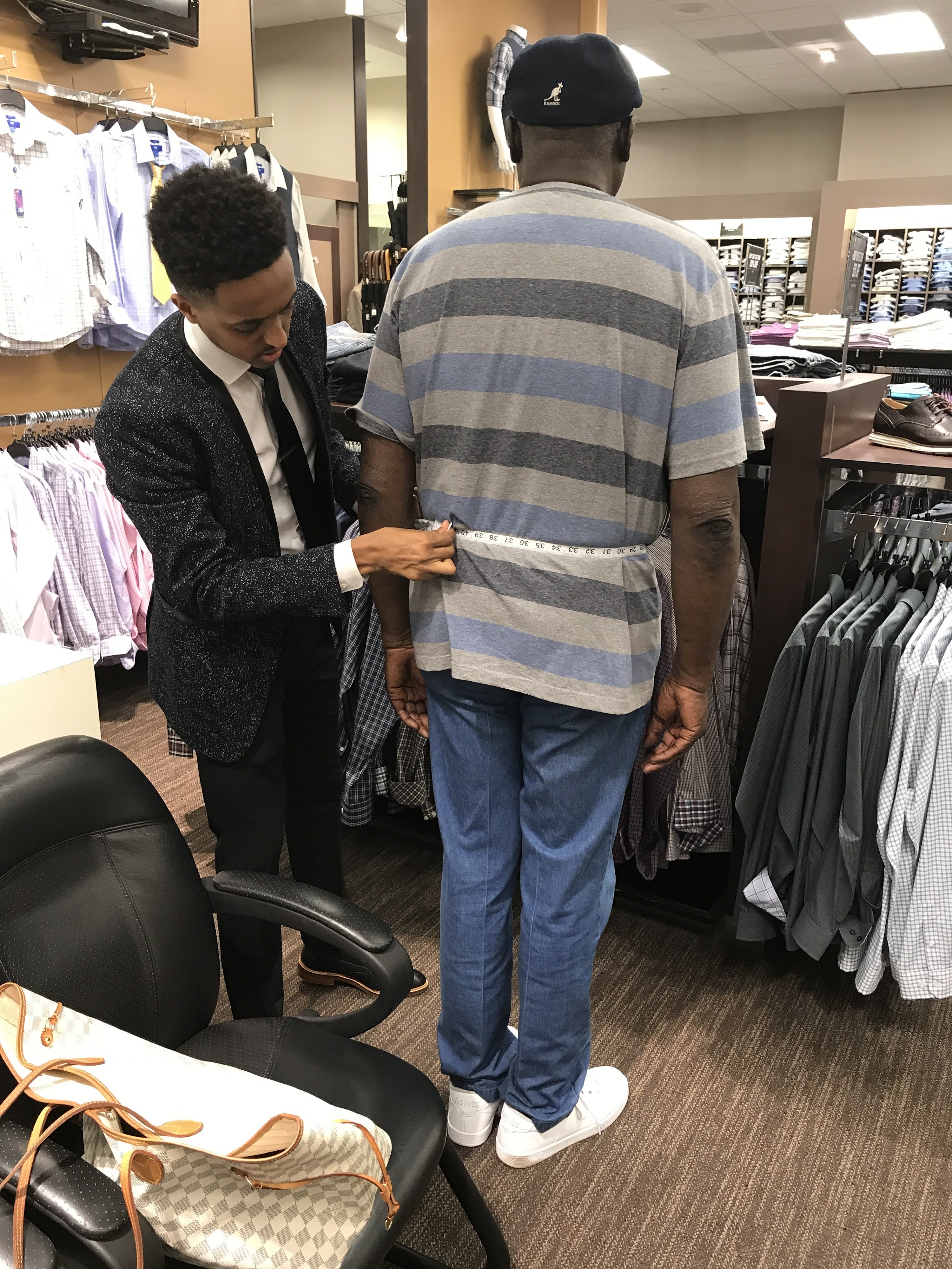 A man measuring a man's waist