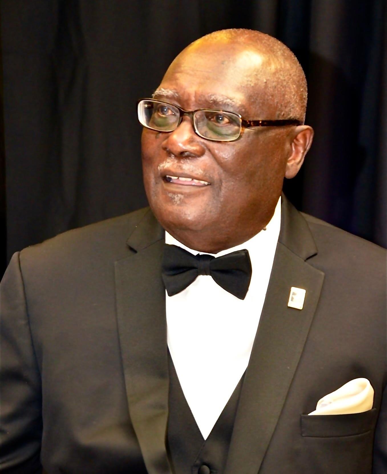 A man in a suit and bow tie