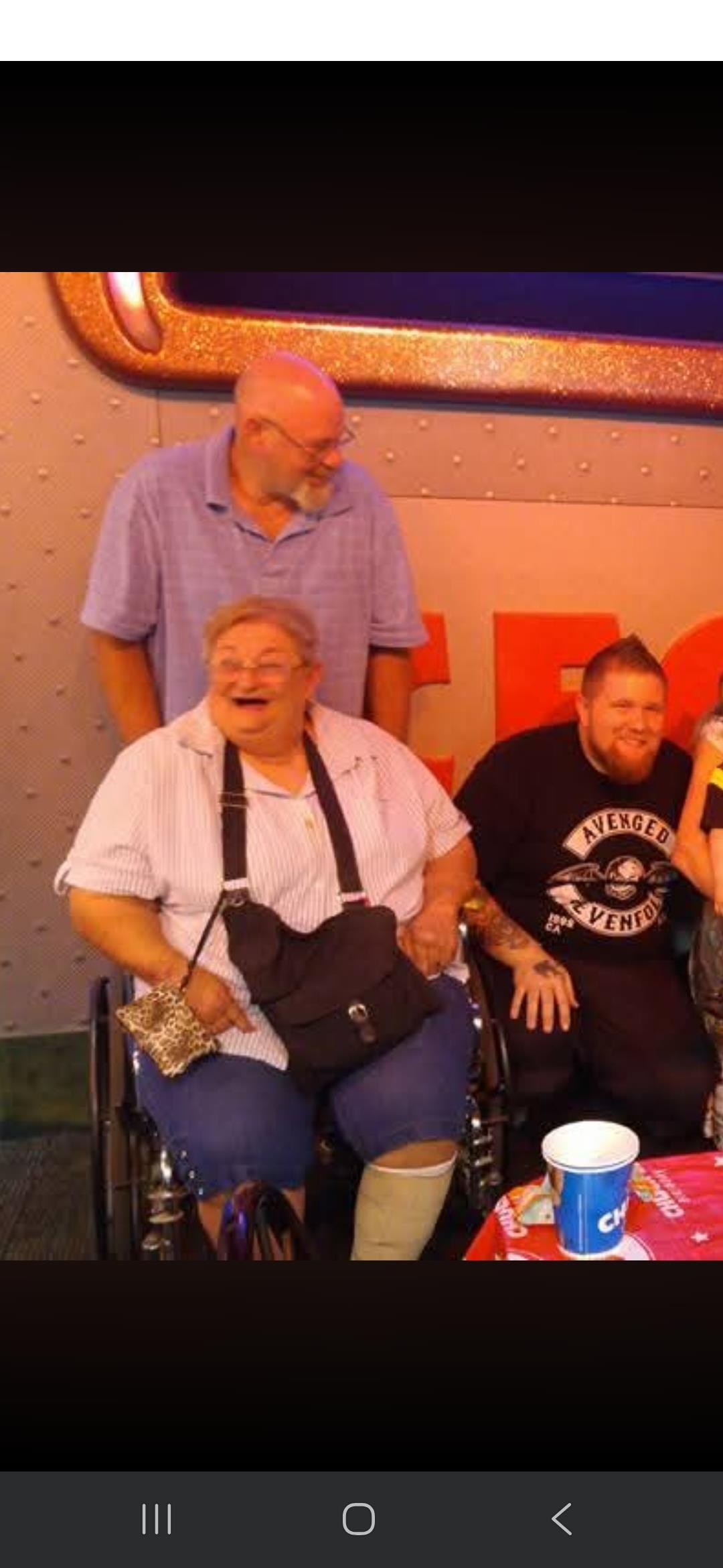 A woman in a wheelchair with a group of people behind her