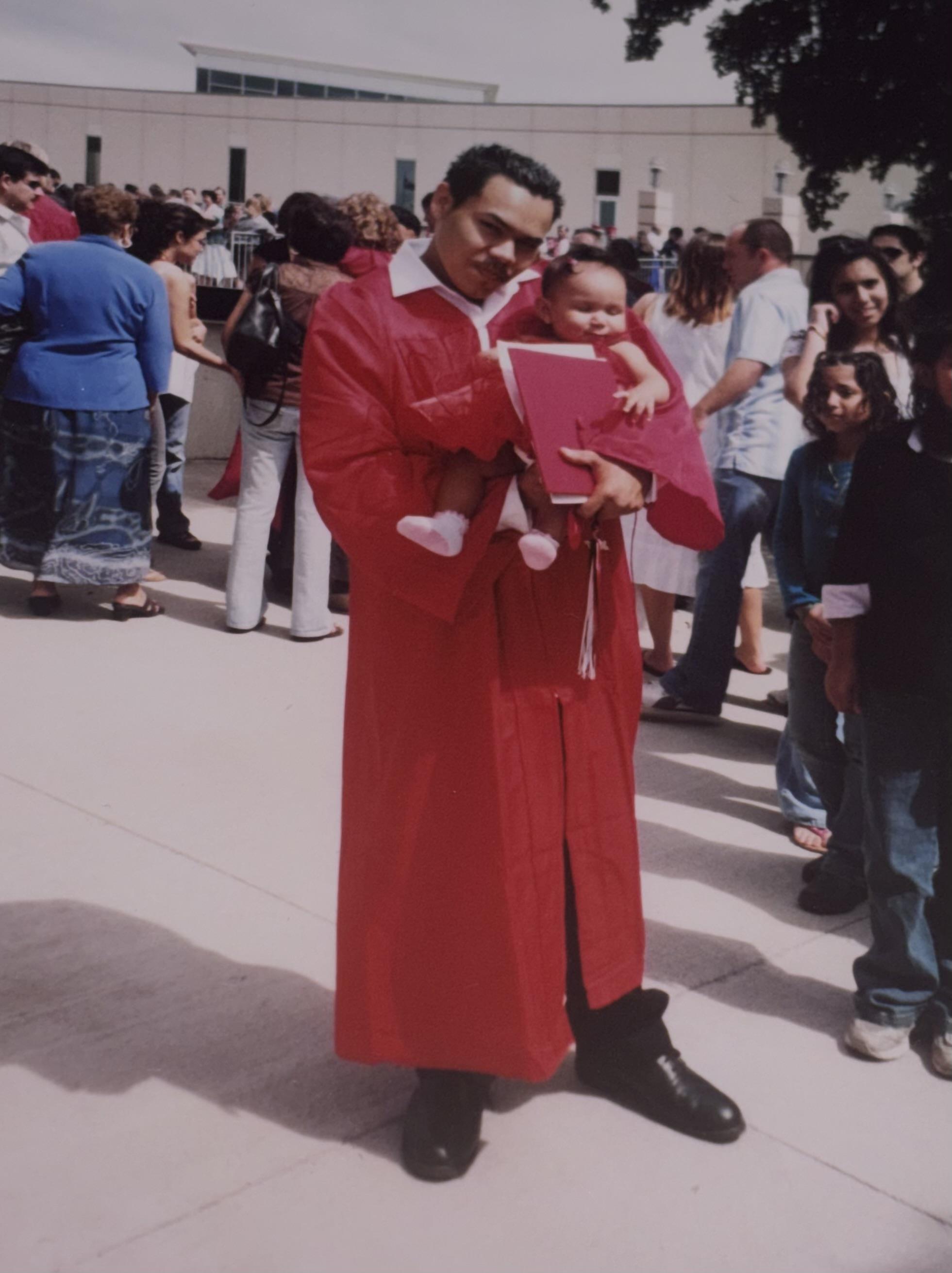 A man in a robe holding a baby