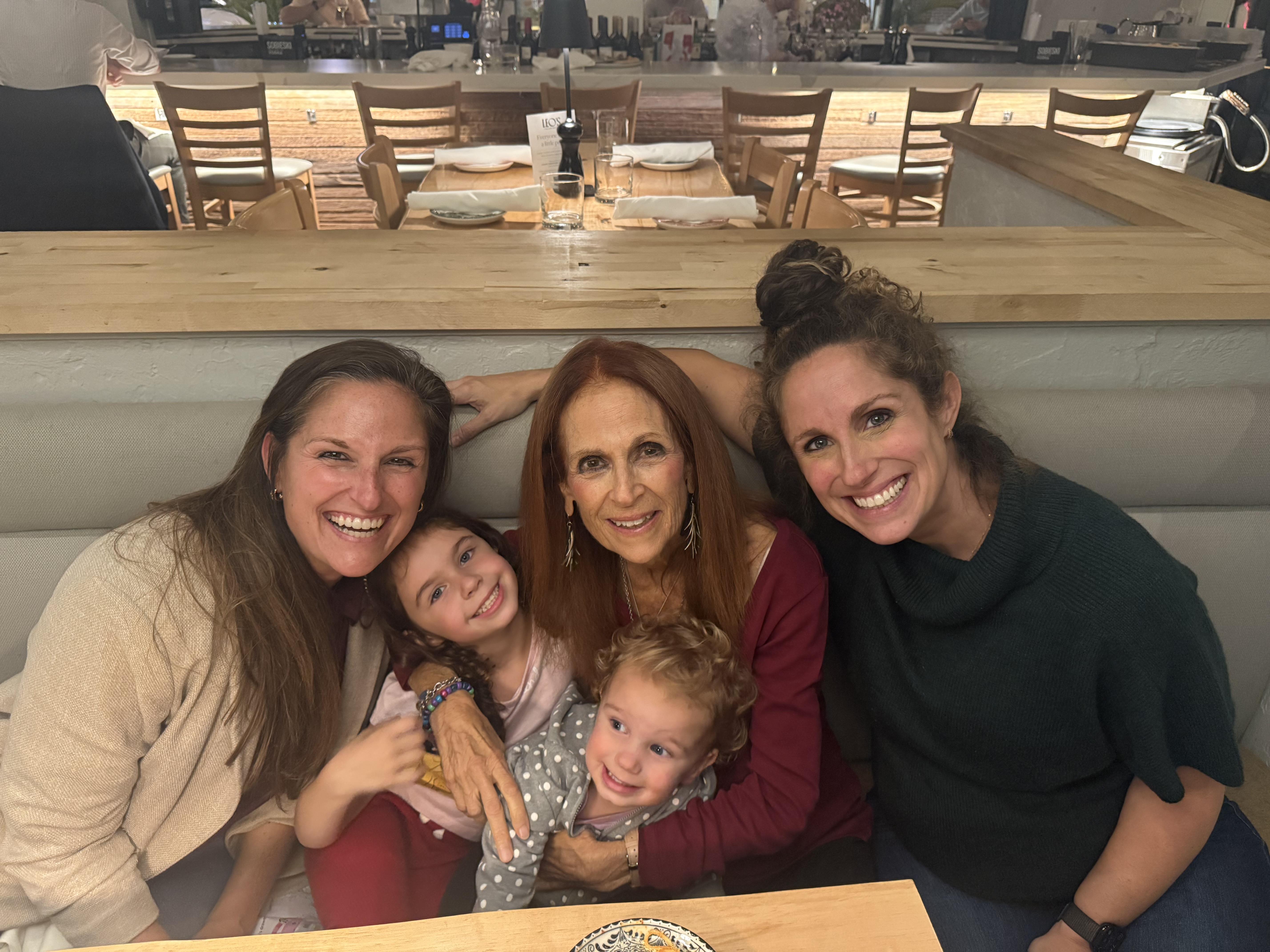 A group of women sitting together smiling