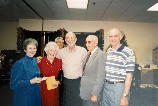 A group of old people posing for a photo