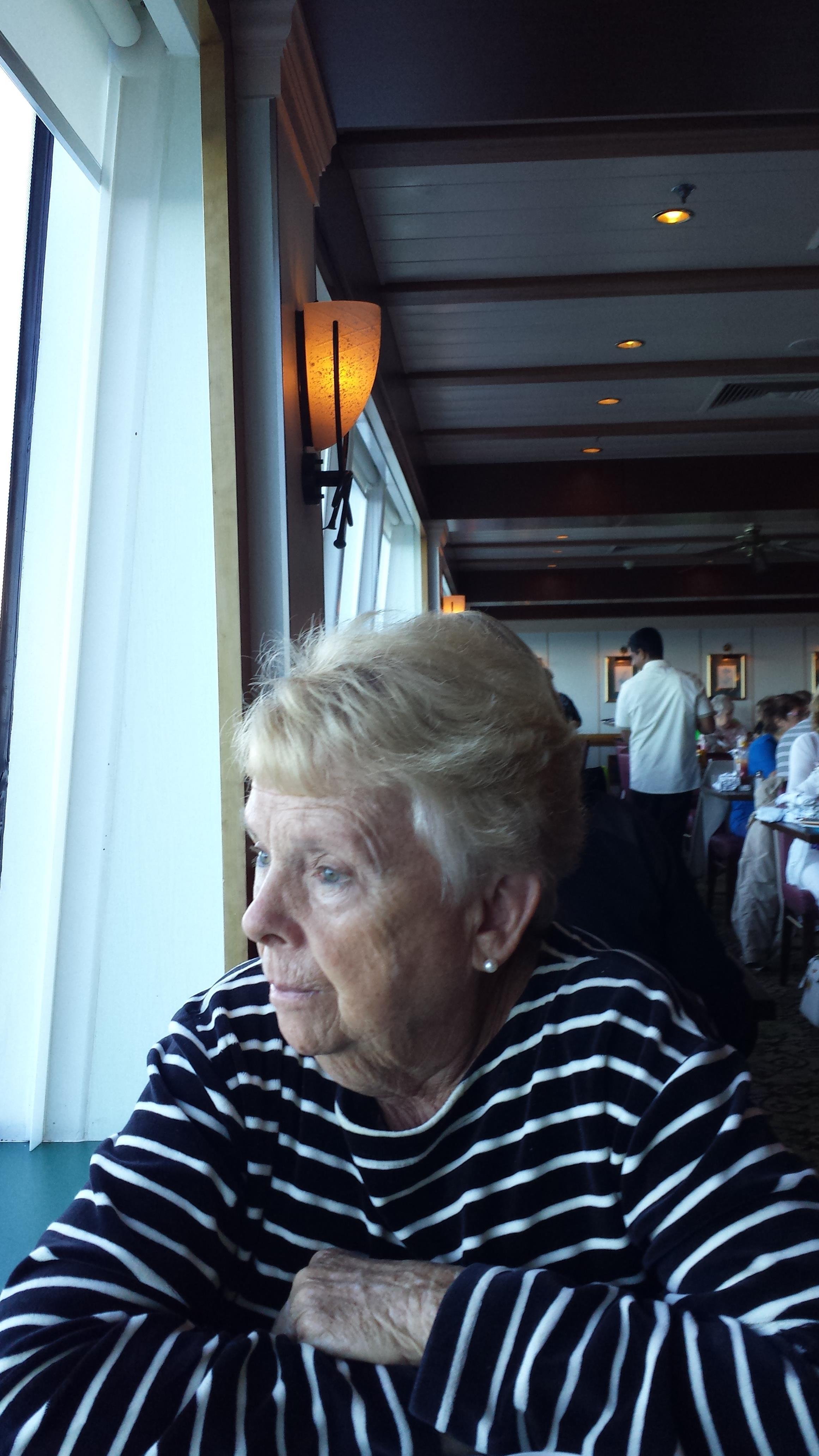 An old woman looking out a window